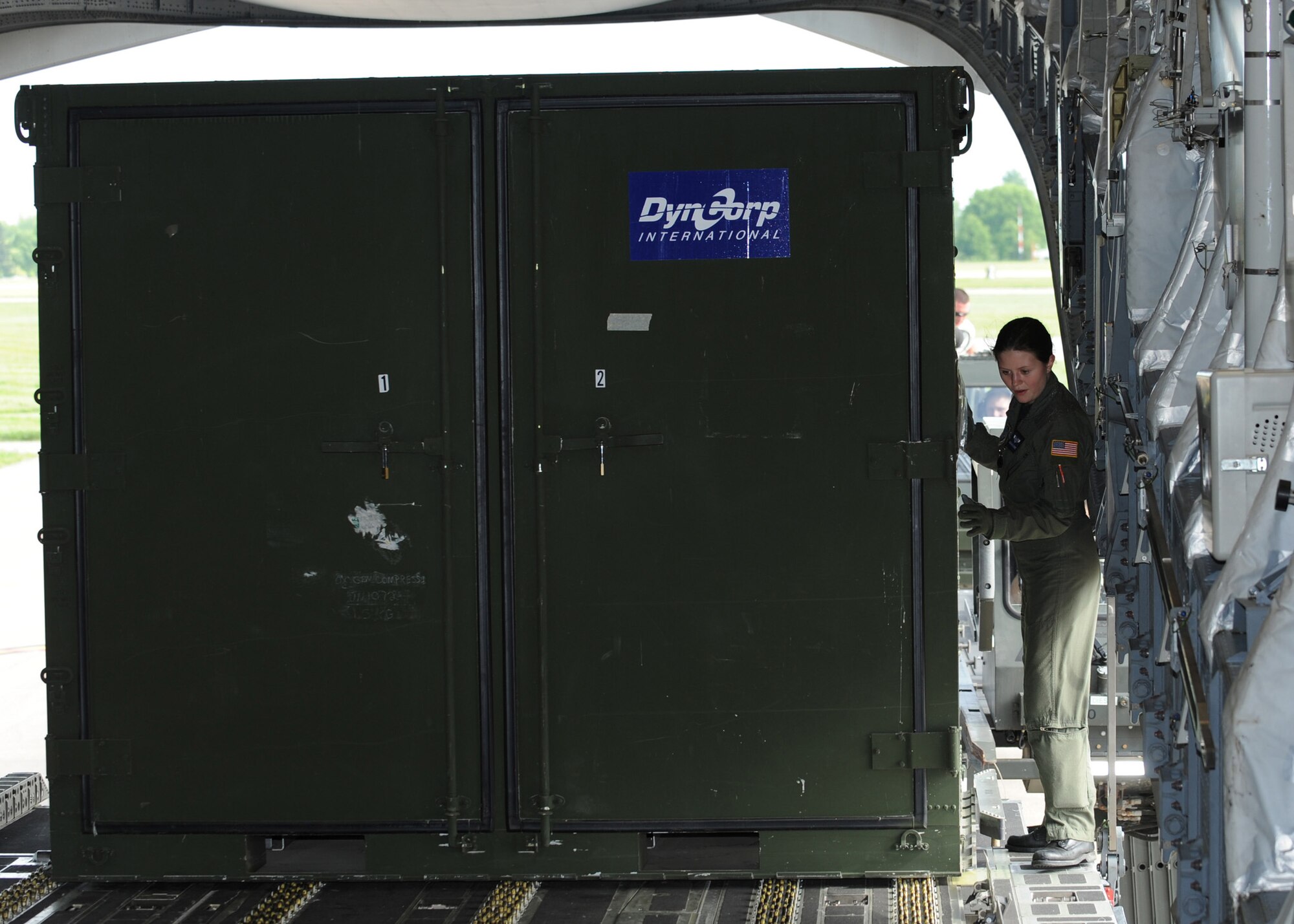 SCOTT AIR FORCE BASE, Ill. -- Airman 1st Class Samantha Earnest, loadmaster with the 6th Airlift Squadron at McGuire Air Force Base, N.J., positions cargo for a flight aboard a C-17 Globemaster III at Scott Air Force Base, Ill., May 12. The cargo will be flown to Volk Field, Wisc., where 375th Airlift Wing Airmen will train with the Minnesota Air National Guard 133rd Airlift Wing and the 94th Arial Port Squadron (Reserve) from Robins Air Force Base, Ga. in preparation for the wing's for the operational readiness inspection in March 2010.  (U.S. Air Force photo/Staff Sgt. Paul Villanueva II)