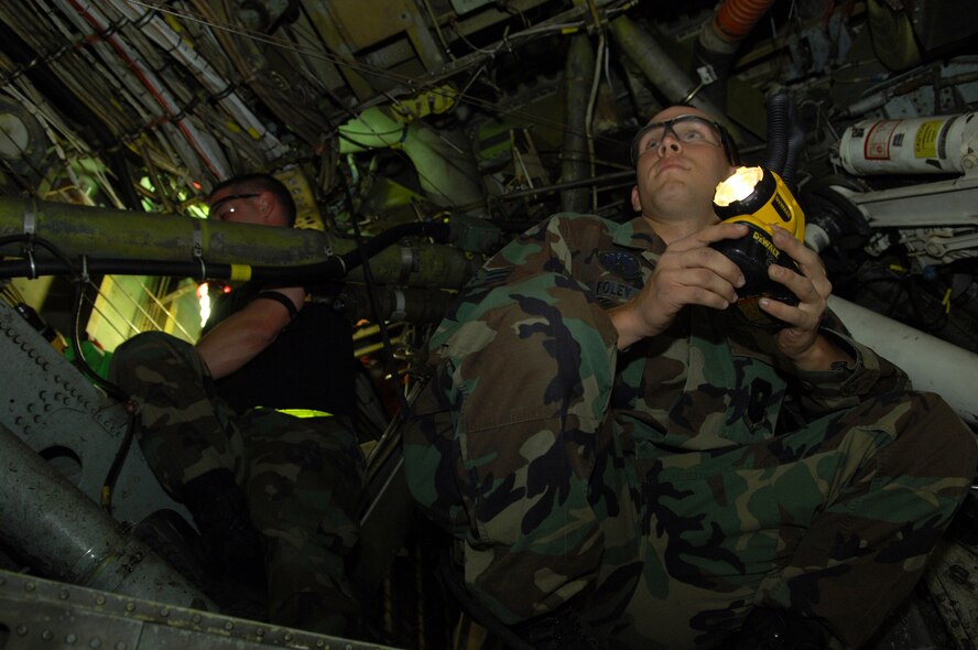 MINOT AIR FORCE BASE, N.D. - Airman 1st Class Brayden Foley (front) and Senior Airman Robert Stephens, both 5th Maintenance Squadron, perform a wheel well corrosion inspection on a B-52H Stratofortress here May 7. A one-fourth inch crack was discovered while the aircraft was deployed to Guam. After five months of planning and coordination among four bases, squadron members successfully completed a manual, full-aircraft “jack and cradle” repair of the B-52. (U.S. Air Force photo by Tech. Sgt. Lee Osberry)