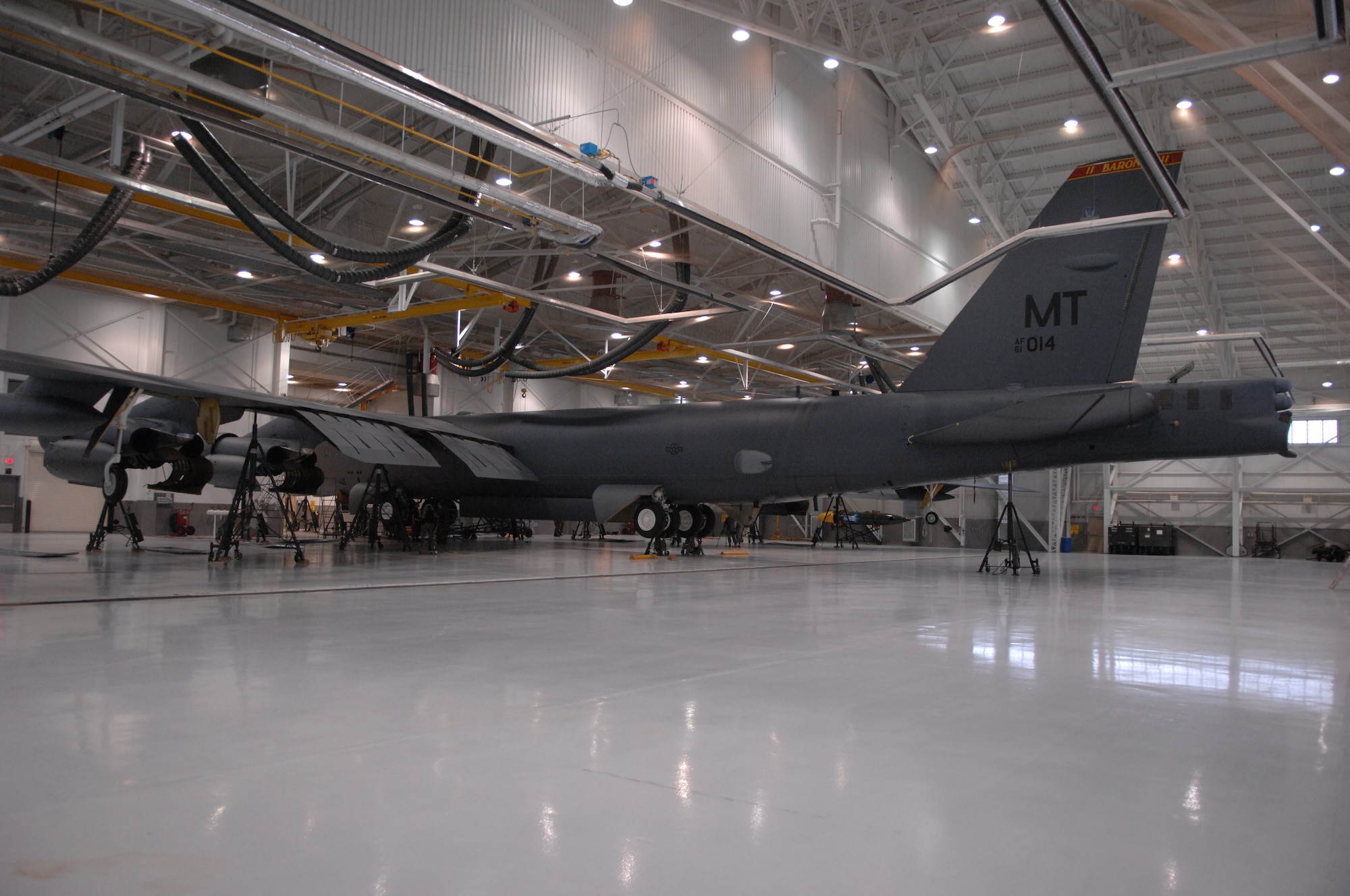 MINOT AIR FORCE BASE, N.D. -- Members from the 5th Maintenance Squadron work on a B-52H Stratofortress here May 7. A one-fourth inch crack was discovered while the aircraft was deployed to Guam. After five months of planning and coordination among four bases, squadron members successfully completed a manual, full-aircraft “jack and cradle” repair of the B-52. (U.S. Air Force photo by Staff Sgt. Angel Gallardo)