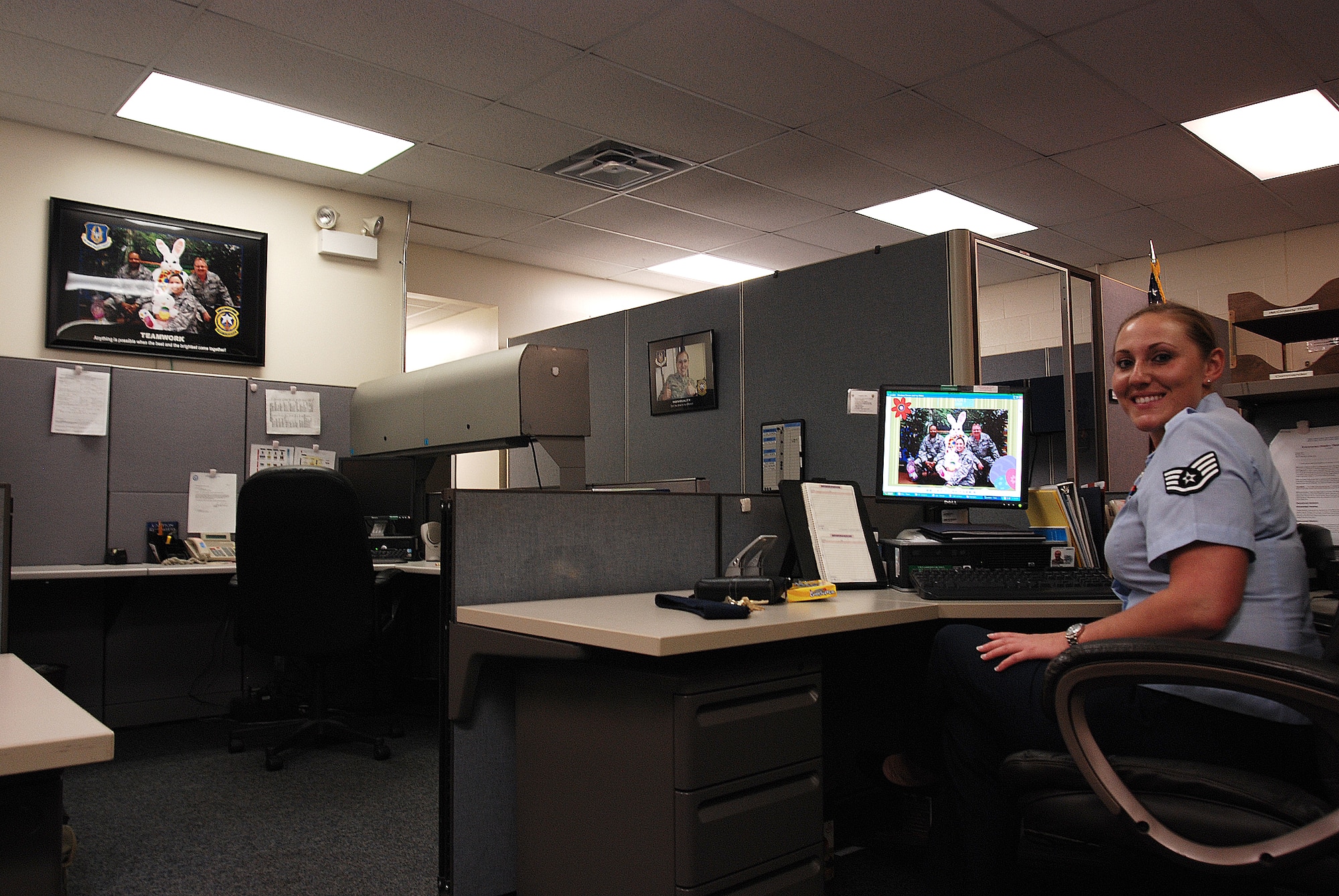 Staff Sergeant Amanda Stephens, a knowledge operations manager for the 710th Information Operations Flight, a Reserve unit at Brooks City-Base, Texas, sits at her desk showing off some of the motivational posters she made. The 433rd Airlift Wing provides medical support and mission-essential training for the 710th IOF and Sergeant Stephens is the one who keeps the unit organized and ready. (U.S. Air Force Photo/Airman Brian McGloin)