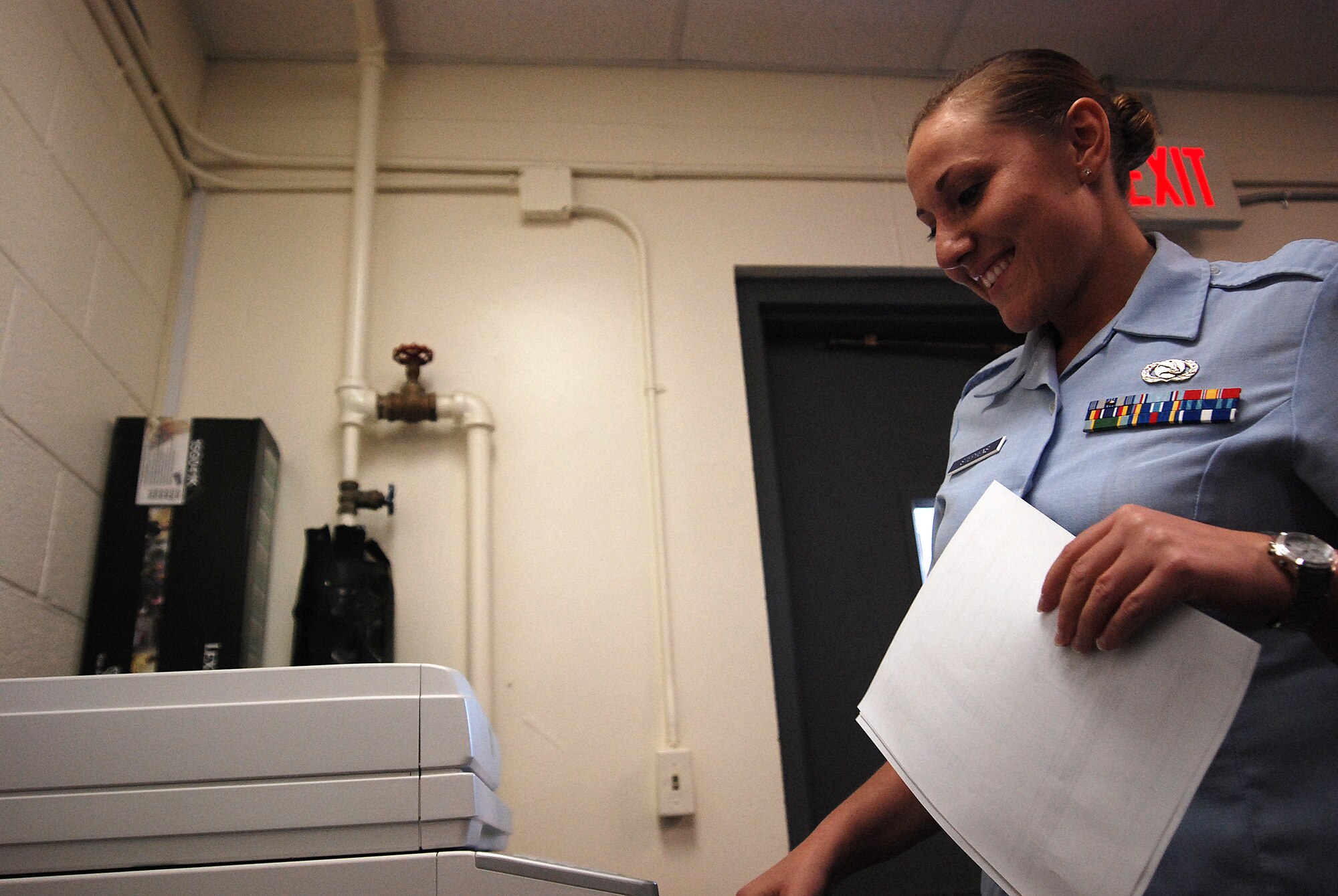 Staff Sergeant Amanda Stephens, a knowledge operations manager for the 710th Information Operations Flight, a Reserve unit at Brooks City-Base, TX, smiles for even the mundane tasks her multi-faceted job requires during the day. The 433rd Airlift Wing provides medical support and mission-essential training for the 710th IOF and Sergeant Stephens is the one who keeps  the unit organized and ready. (U.S. Air Force Photo/Airman Brian McGloin)