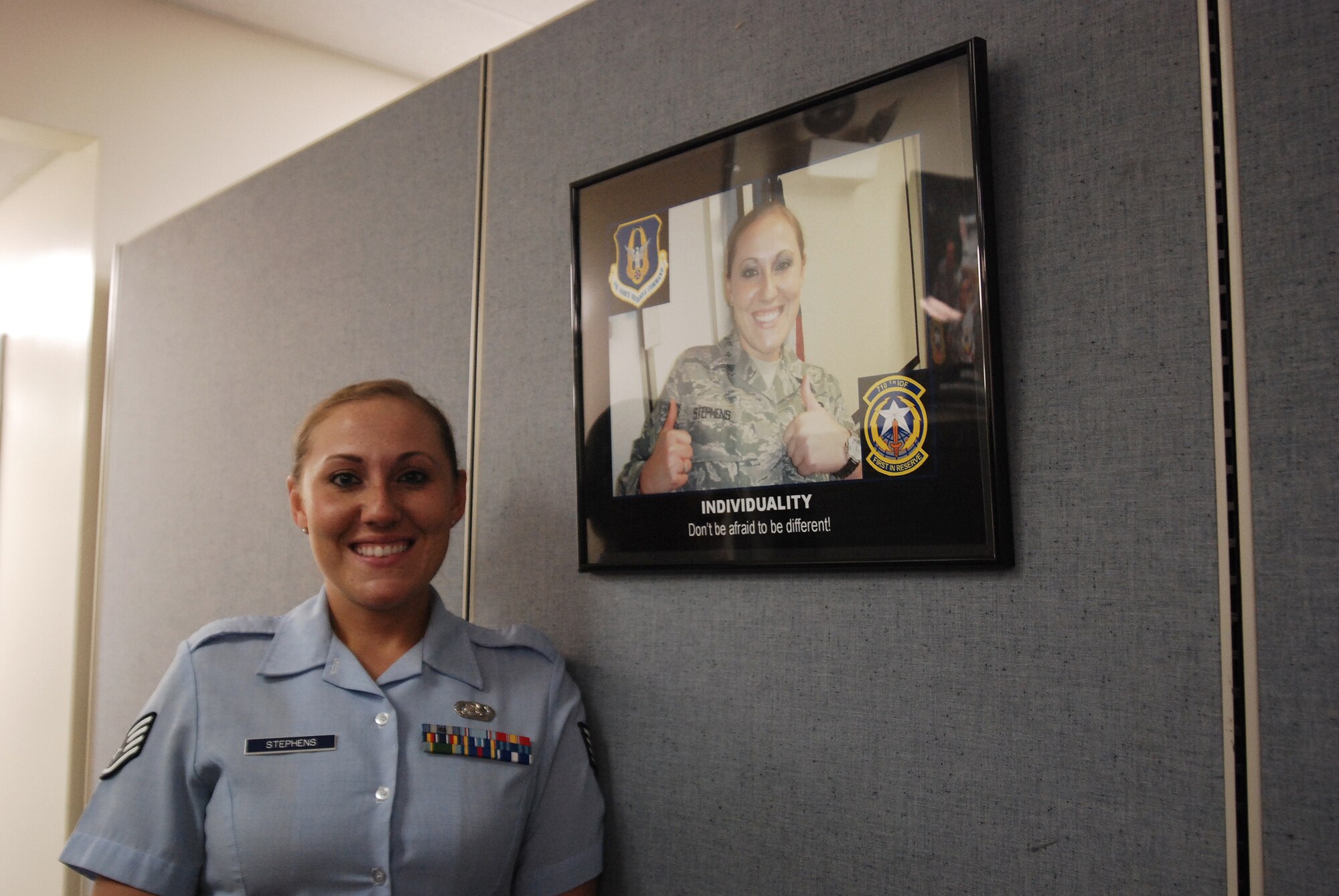 Staff Sergeant Amanda Stephens, a knowledge operations manager for the 710th Information Operations Flight, a Reserve unit at Brooks City-Base, Texas, stands next to one of the motivational posters she made, which also has her photo in it. The 433rd Airlift Wing provides medical support and mission-essential training for the 710th IOF and Sergeant Stephens is the one who keeps  the unit organized and ready. (U.s. Air Force Photo/Airman Brian McGloin)