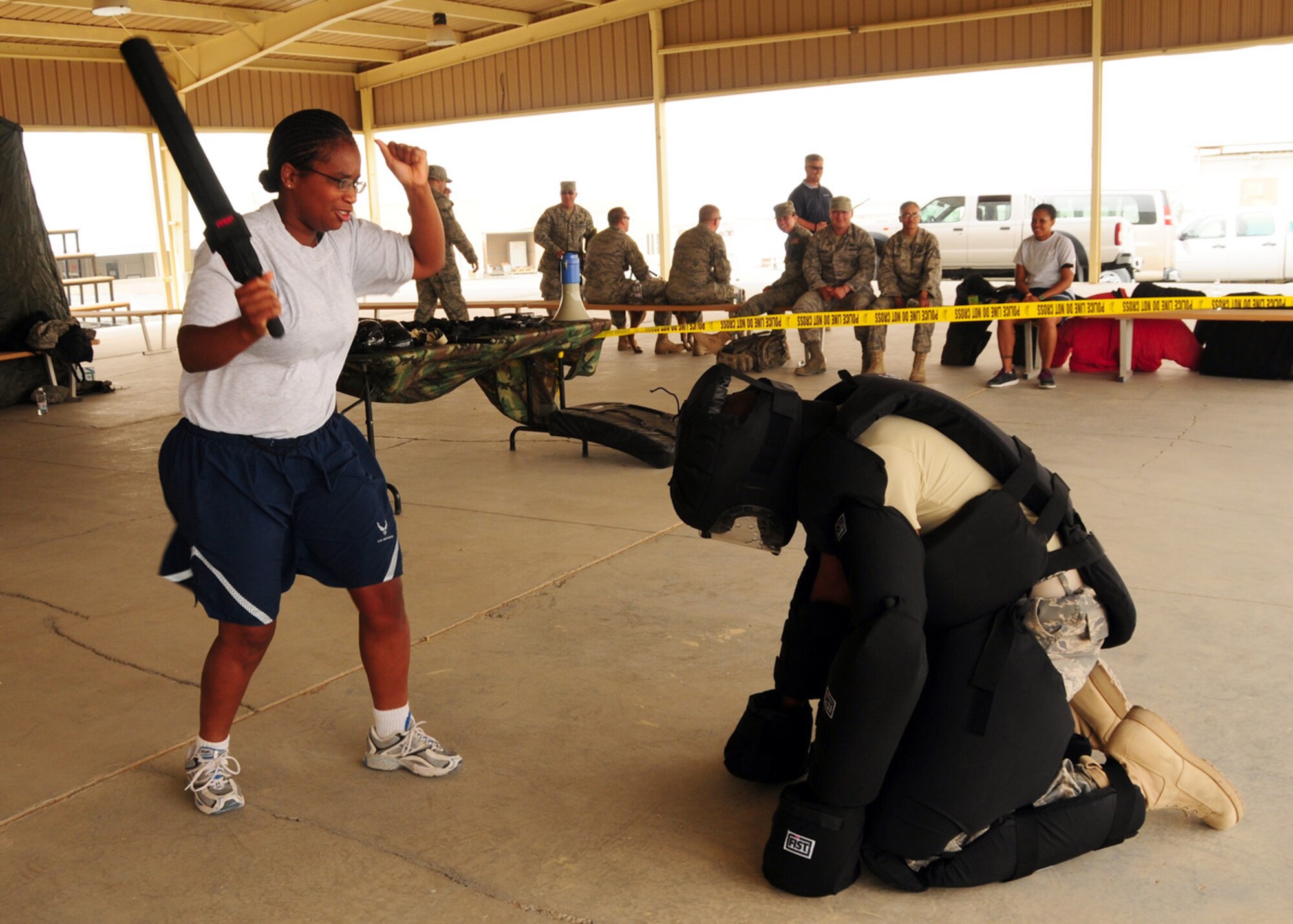 SOUTHWEST ASIA -- Capt. Deborah Hughley, 386th Air Expeditionary Wing chaplain, takes down a simulated enemy using an Armament Systems and Procedures Baton during Police Week at an air base in Southwest Asia, May 11.  The ASP Baton provides security forces members an alternate use of force. Captain Hughley is currently deployed from Andrews Air Force Base, Md. (U.S. Air Force photo/ Senior Airman Courtney Richardson)