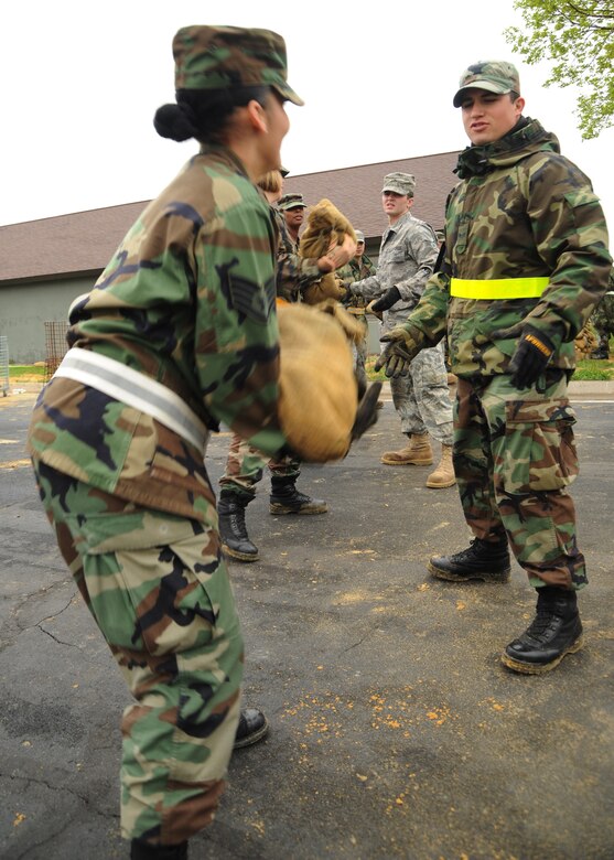 VOLK FIELD, Wisc.--Members of the 375th Airlift Wing Director of Staff pass sandbags to build a defensive fighting position outside a building on Volk Field, Wisc., May 13. The Airmen from Scott are part of a team participating in a week-long training exercise at Volk Field involving active duty Airmen along with members of the Air National Guard and Air Force Reserve. (U.S. Air Force photo/Airman 1st Class Wesley Farnsworth)
