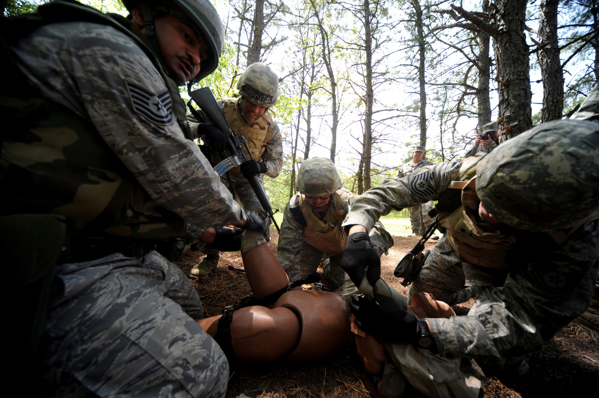 Students in the Advanced Contigingency Skills Training Course practice combat first aid techniques May 11, 2009 on a simulated injury victim during a training scenario on a Fort Dix, N.J. range.  The training taught by the  U.S. Air Force Expeditionary Center's 421st Combat Training Squadron prepares Airmen for upcoming deployments providing combat skills training in everything from combat first aid and convoy operations to patrolling and tactics.   (U.S. Air Force Photo/Staff Sgt. Nathan G. Bevier) 