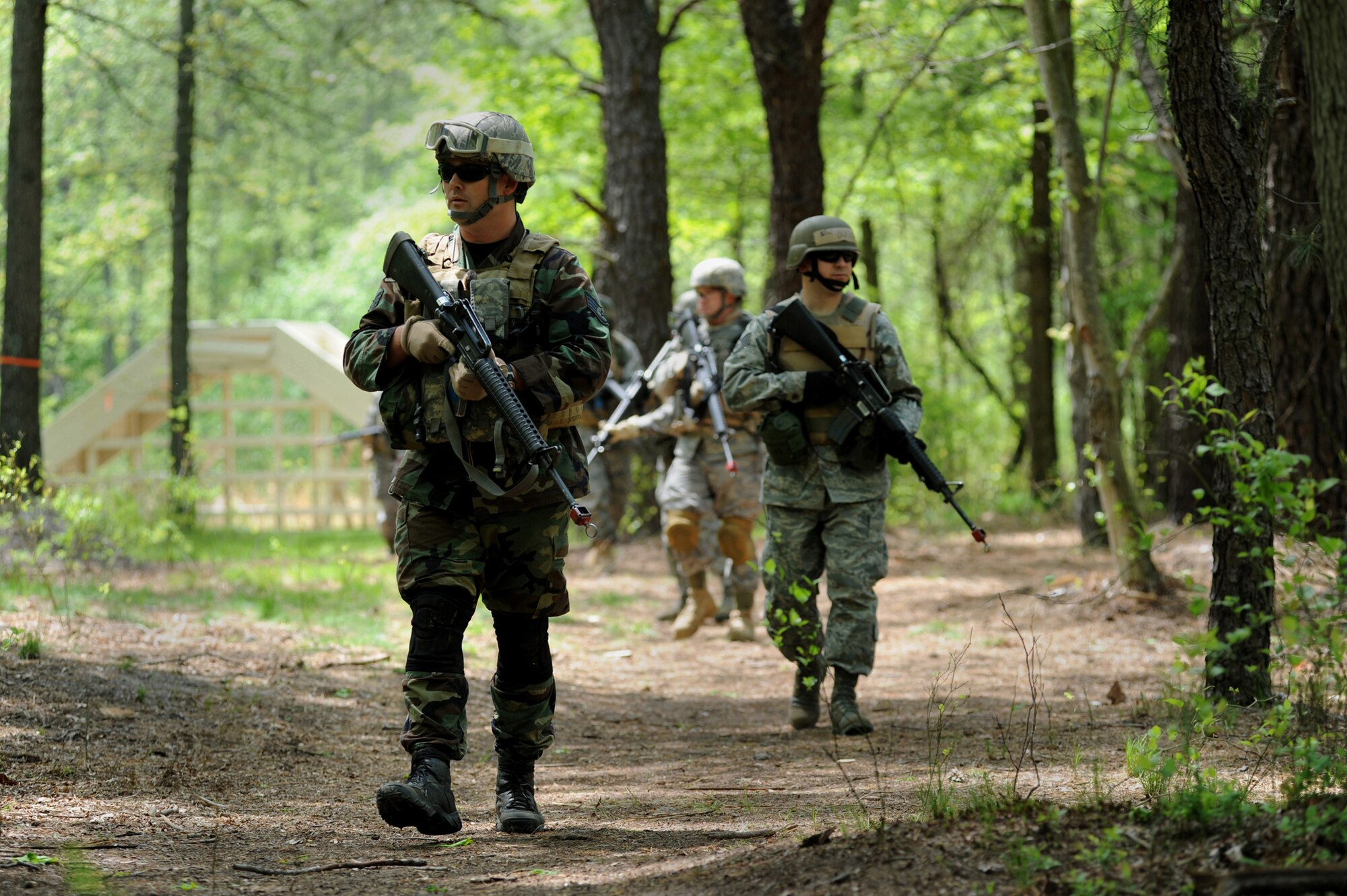 Student in the Advanced Contigingency Skills Training Course walk in a patrol formation during training on a Fort Dix, N.J. range on May 11, 2009.  The training taught by the  U.S. Air Force Expeditionary Center's 421st Combat Training Squadron on Fort Dix, prepares Airmen for upcoming deployments.   (U.S. Air Force Photo/Staff Sgt. Nathan G. Bevier) 