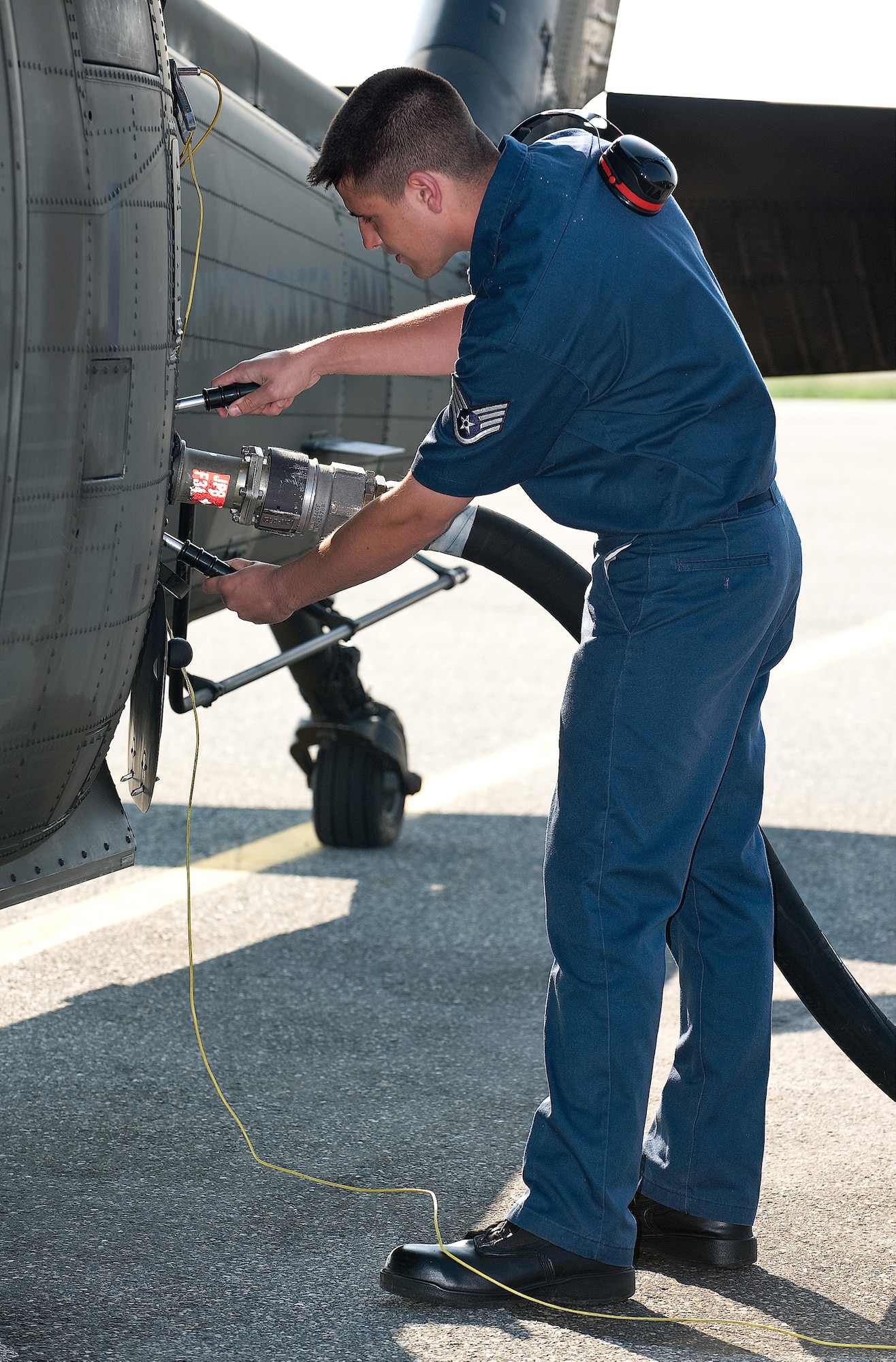 (RELEASED) Staff Sgt. Vance Morris, 436th Aircraft Maintenance Squadron Transient Maintenance Flight, refuels a helicopter at Dover Air Force Base May 12. Transient maintenance recovers, services and launches non-Dover assigned aircraft that transit Dover AFB. (U.S. Air Force Photo/Roland Balik)