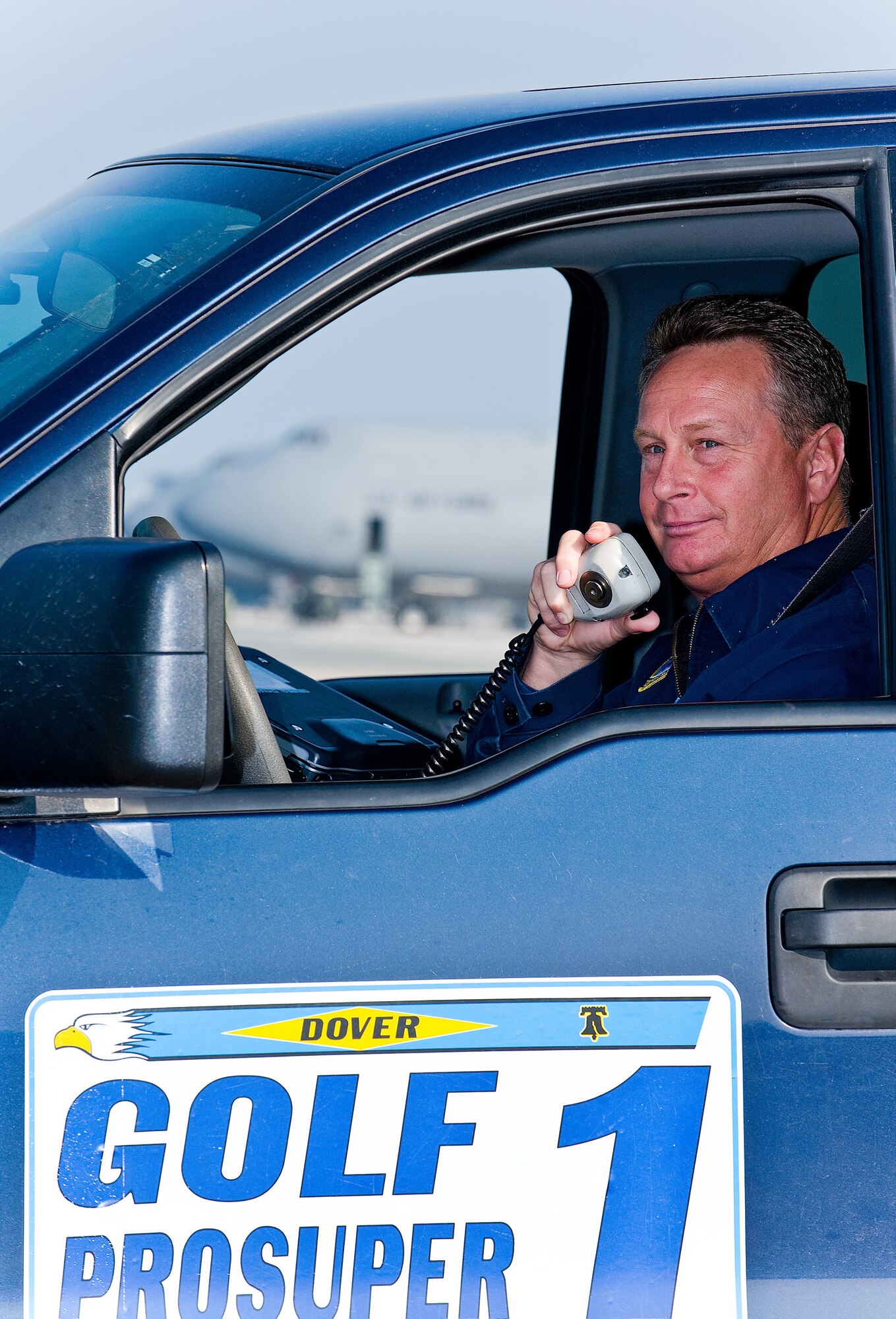 (RELEASED) Geoff Chandler, 436th Aircraft Maintenance Squadron Transient Maintenance Flight, listens to the radio while waiting to guide a transient aircraft at Dover Air Force Base May 12. Transient maintenance recovers, services and launches non-Dover assigned aircraft that transit Dover AFB. (U.S. Air Force Photo/Roland Balik)