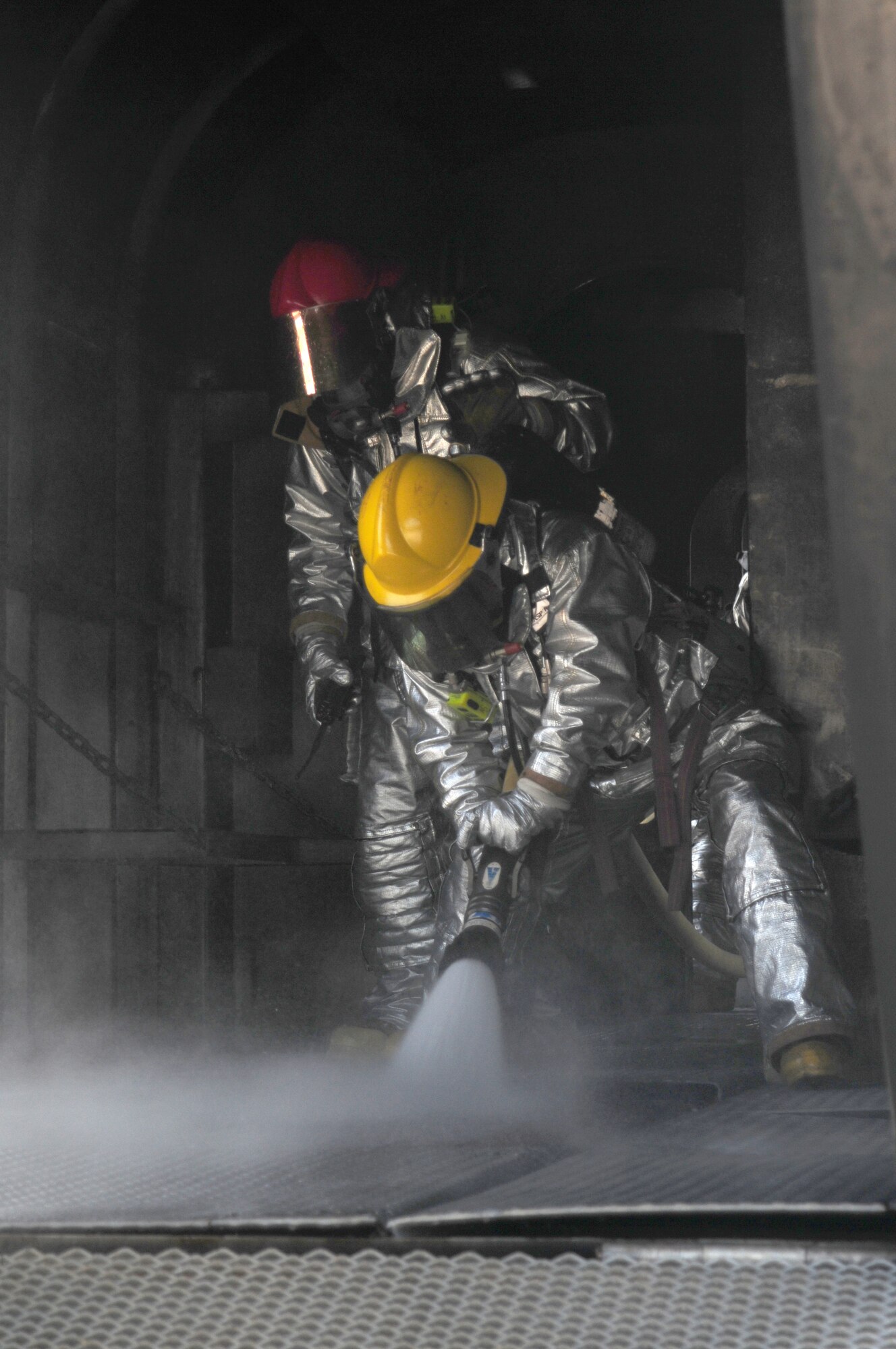 Fire fighters from the 18th Civil Engineer Squadron, make sure the flames on a simulated aircraft have been completely extinguished,  during the Beverly High 09-2 Local Operational Readiness Exercise May 14. The LORE tests base personnel on their combat readiness for real world emergency/combat  events. (U.S. Air Force photo/Staff Sgt. Lakisha A. Croley )