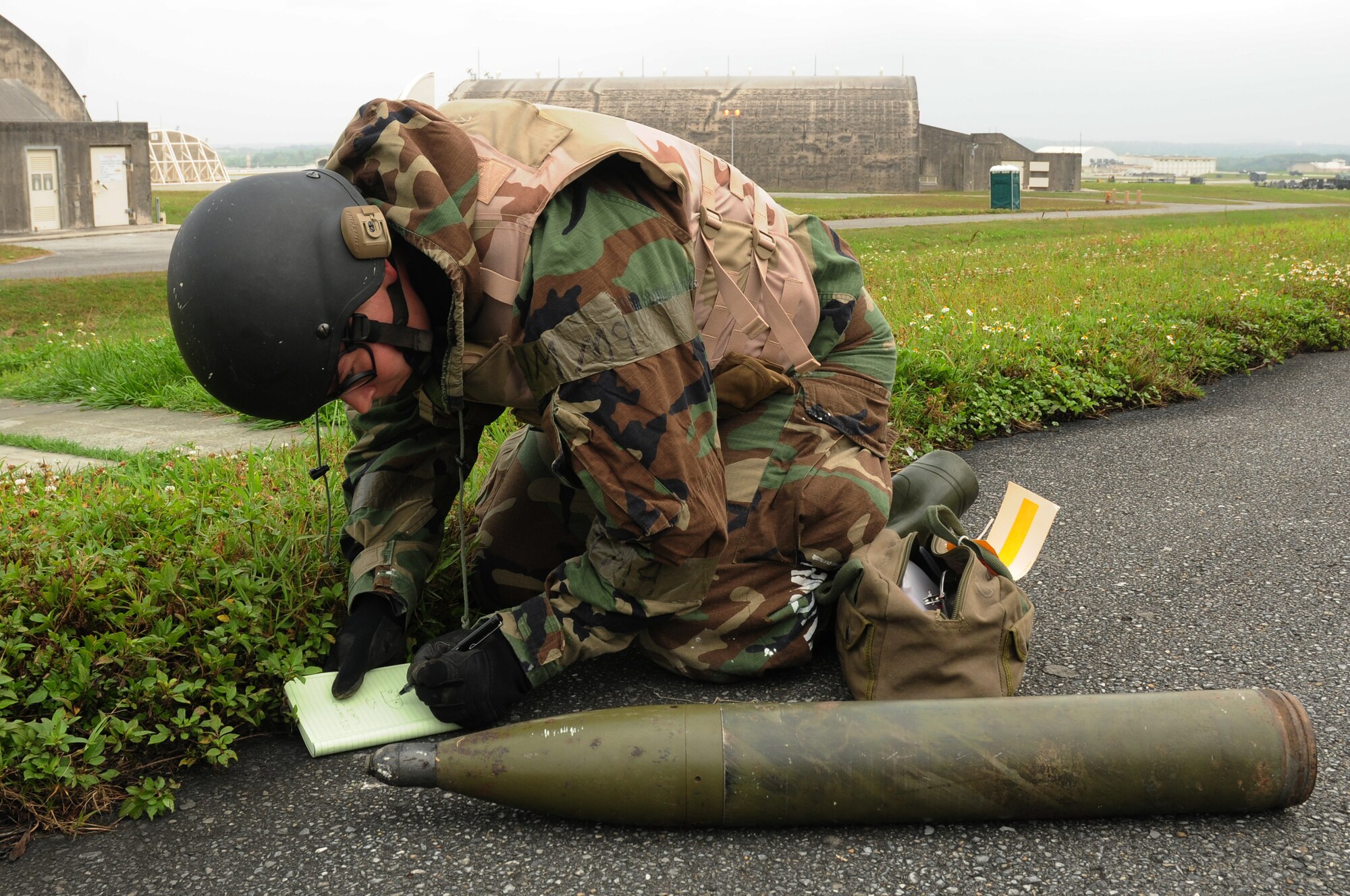 Senior Airman Jessica Roland, 18th Civil Engineer Squadron explosive ordnance disposal craftsman, looks at the unidentified explosive ordnance to determine the proper way to dispose of the UXO during the Beverly High 09-2 Local Operational Readiness Exercise May 14. The LORE tests base personnel on their combat readiness for real world emergency/combat events.
(U.S. Air Force photo/Airman 1st Class Amanda Grabiec)