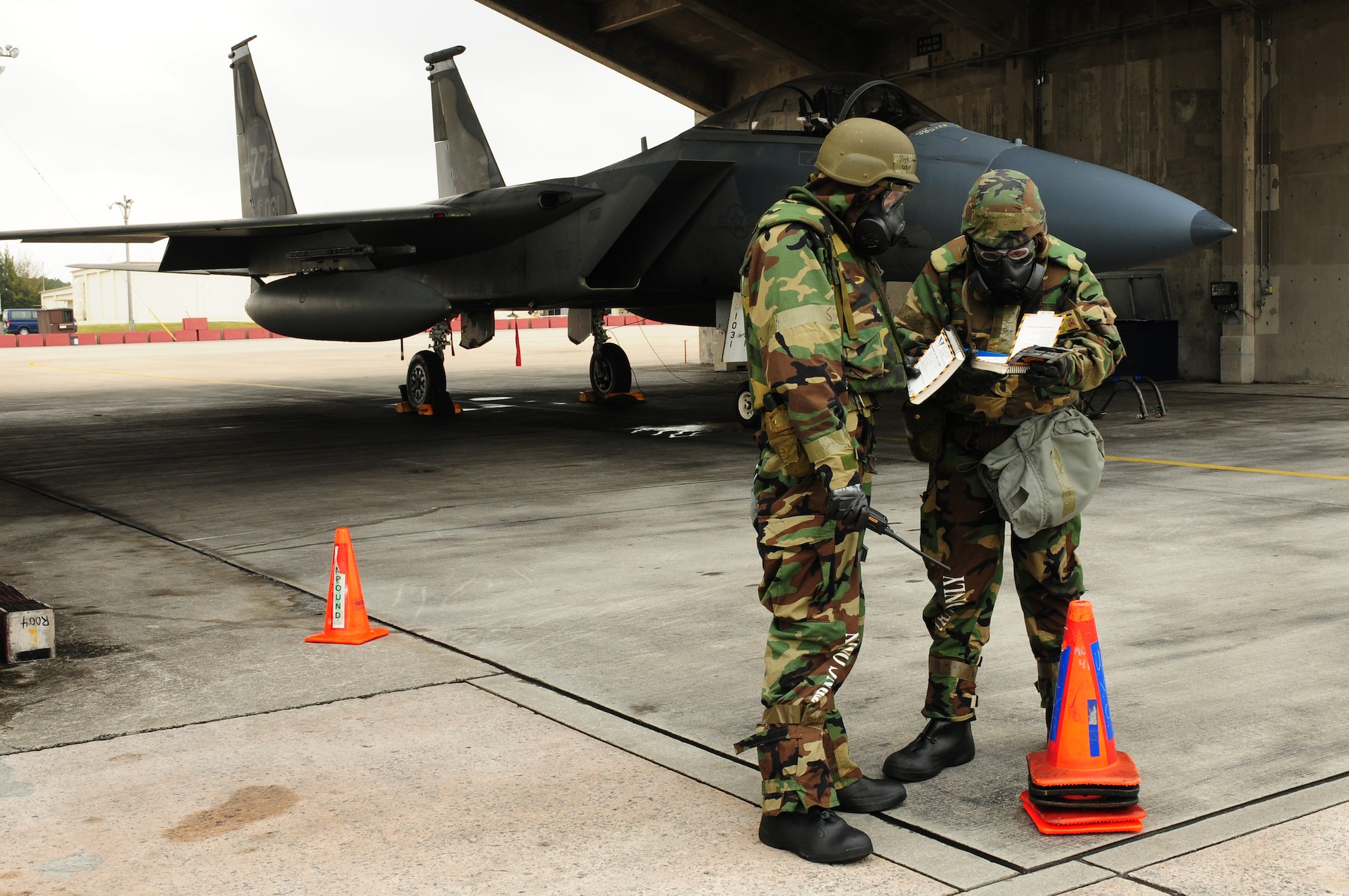 Airmen from the 18th Aircraft Maintenance Squadron look through their Airman?s Manual to determine the steps to take when finding an unidentified explosive ordnance during the Beverly High 09-2 Local Operational Readiness Exercise May 14. The LORE tests base personnel on their combat readiness for real world emergency/combat events.
(U.S. Air Force photo/Airman 1st Class Amanda Grabiec)