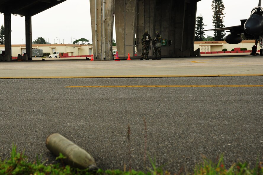 Airmen from the 18th Aircraft Maintenance Squadron look through their Airman?s Manual to determine the steps to take when finding an unidentified explosive ordnance during the Beverly High 09-2 Local Operational Readiness Exercise May 14. The LORE tests base personnel on their combat readiness for real world emergency/combat events.(U.S. Air Force photo/Airman 1st Class Amanda Grabiec)
