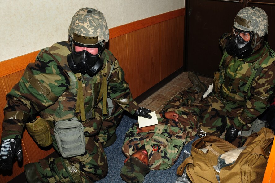 Kadena Airman currently deployed to 'Base X' perform self-aid and buddy care on a simulated injured victim during Beverly High 09-2 Local Operational Readiness Exercise May 13. The LORE tests base personnel on their combat readiness for real world emergency/combat events. (U.S. Air Force photo/Airman 1st Class Amanda Grabiec)
