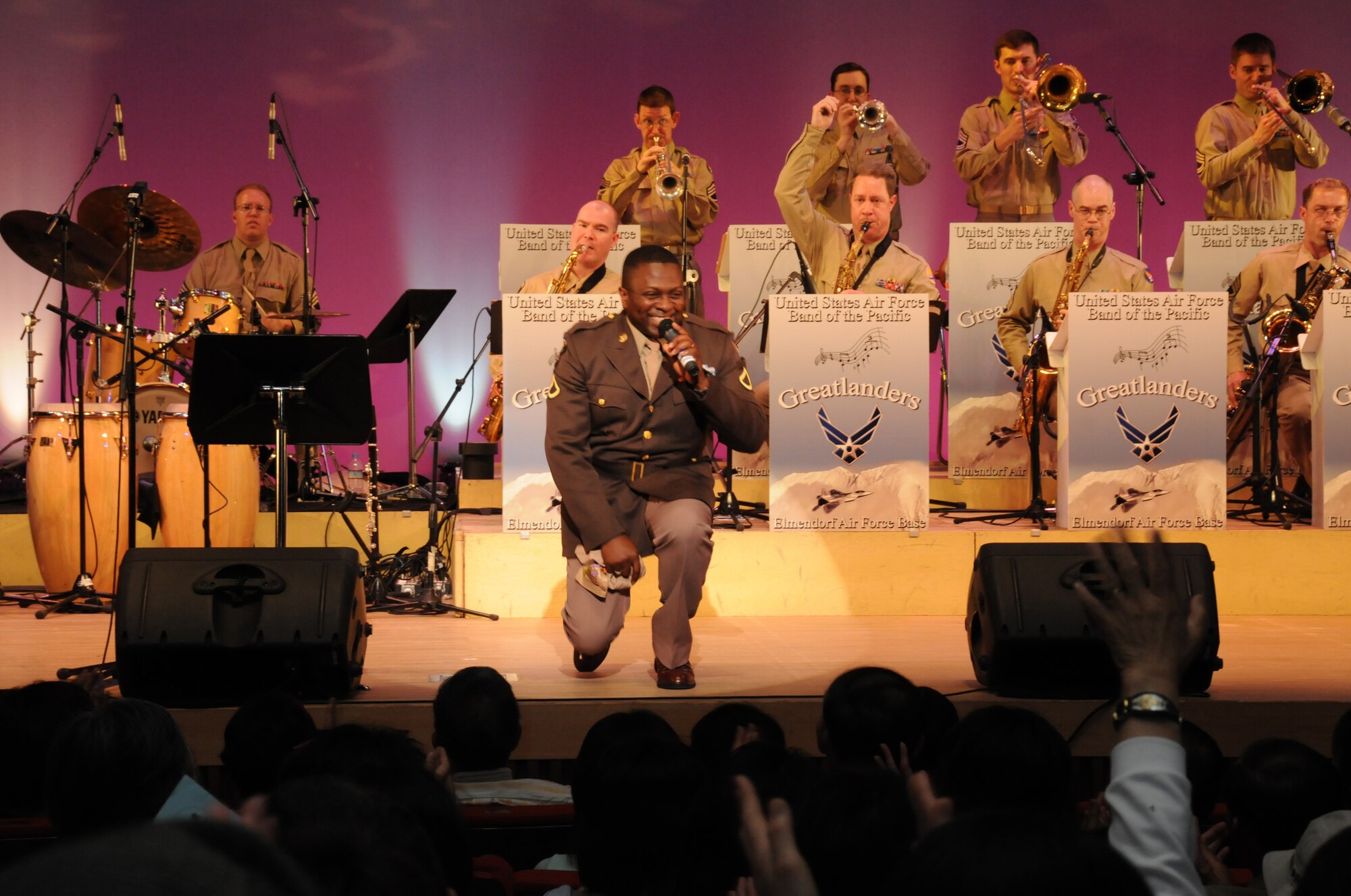 OME, Japan -- Master Sgt. John Teamer, U. S. Air Force Band of the Pacific, sings to the citizens of Ome during a concert at the city's auditorium May 13. Final Approach, a protocol combo band from Yokota and the Greatlanders, a 15-piece popular music combo from the U.S. Air Force Band of the Pacific at Elmendorf Air Force Base, Alaska, have joined forces for a tour of Japan May 6-17. The newly formed Ome-Yokota Friendship Club sponsored the concert. (U.S. Air Force photo/Tech. Sgt. Kimberly Spinner)
