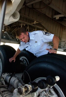 ANDERSEN AIR FORCE BASE, Guam -- Chief Master Sgt. Al Irwin, 734th Air Mobility Squadron superintendent, inspects the landing gear of a C-5 Galaxy May 11. Chief Irwin managed approximately 200 personnel overseeing aircraft maintenance, air transportation and command and control of Cargo movement while stationed at Andersen. (U.S. Air Force photo by Airman Carissa Wolff)           
