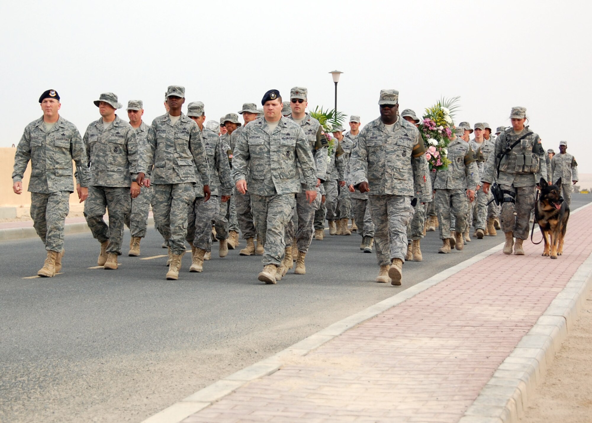 SOUTHWEST ASIA -- Members of the 386th Air Expeditionary Wing participate in a Police Week memorial march May 10 during the kick-off to the week of events held by the 386th and 387th Expeditionary Security Forces Squadrons. The event took marchers to the memorials of fallen security forces Airmen scattered across the Rock where flowers were laid in respect of their sacrifices. (U.S. Air Force photo by Capt. Angelic Dolan)
