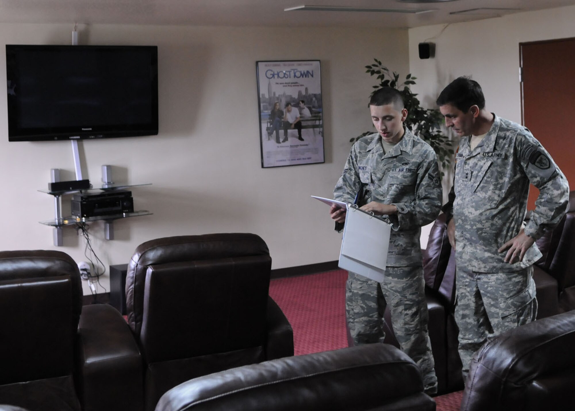 KADENA AIR BASE, Japan -- Airman 1st Class Matthew Punches, 353rd Maintenance Squadron, briefs Maj. Gen.  Salvatore Cambria, the commander of Special Operations Command, Pacific, here May 13 on renovations made to upgrade a dayroom in the 353rd Special Operations Group dormitory into a movie room.  During his final visit to the group in his current position, the general briefed the Air Commandos of the 353rd SOG on the mission and challenges his command faces in the region. The general thanked the men and women assigned to the group for being a critical component of his command and carrying out their mission even though they faced many difficult challenges. (U.S. Air Force photo by Tech. Sgt. Aaron Cram)