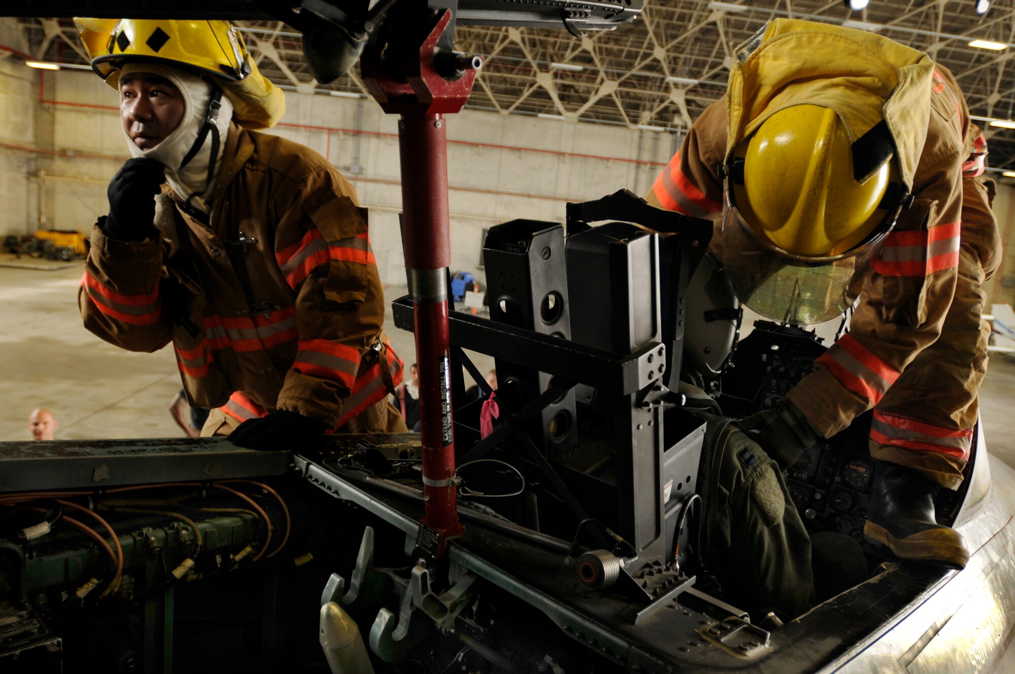 Fire fighters from the 18th Civil Engineer Squadron extract a pilot from an F-15 Eagle during Beverly High 09-2 Local Operational Readiness Exercise May 13. The LORE tests base personnel on their combat readiness for real world emergency/combat events.  (U.S. Air Force photo/Airman 1st Class Chad Warren)