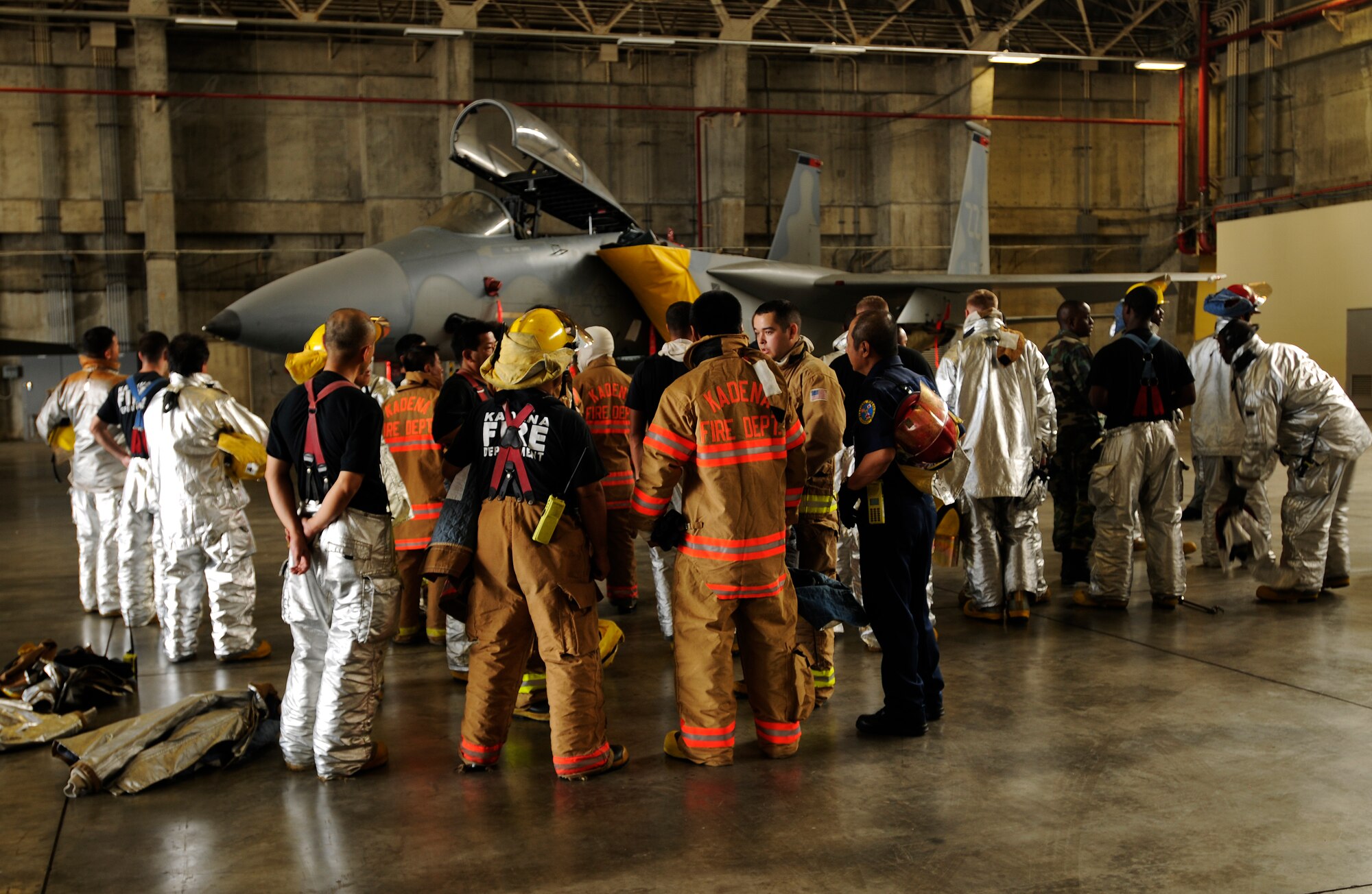 Fire fighters from the 18th Civil Engineer Squadron prepare to extract a pilot from an F-15 Eagle during  Beverly High 09-2 Local Operational Readiness Exercise May 13. The LORE tests base personnel on their combat readiness for real world emergency/combat events.  (U.S. Air Force photo/Airman 1st Class Chad Warren)