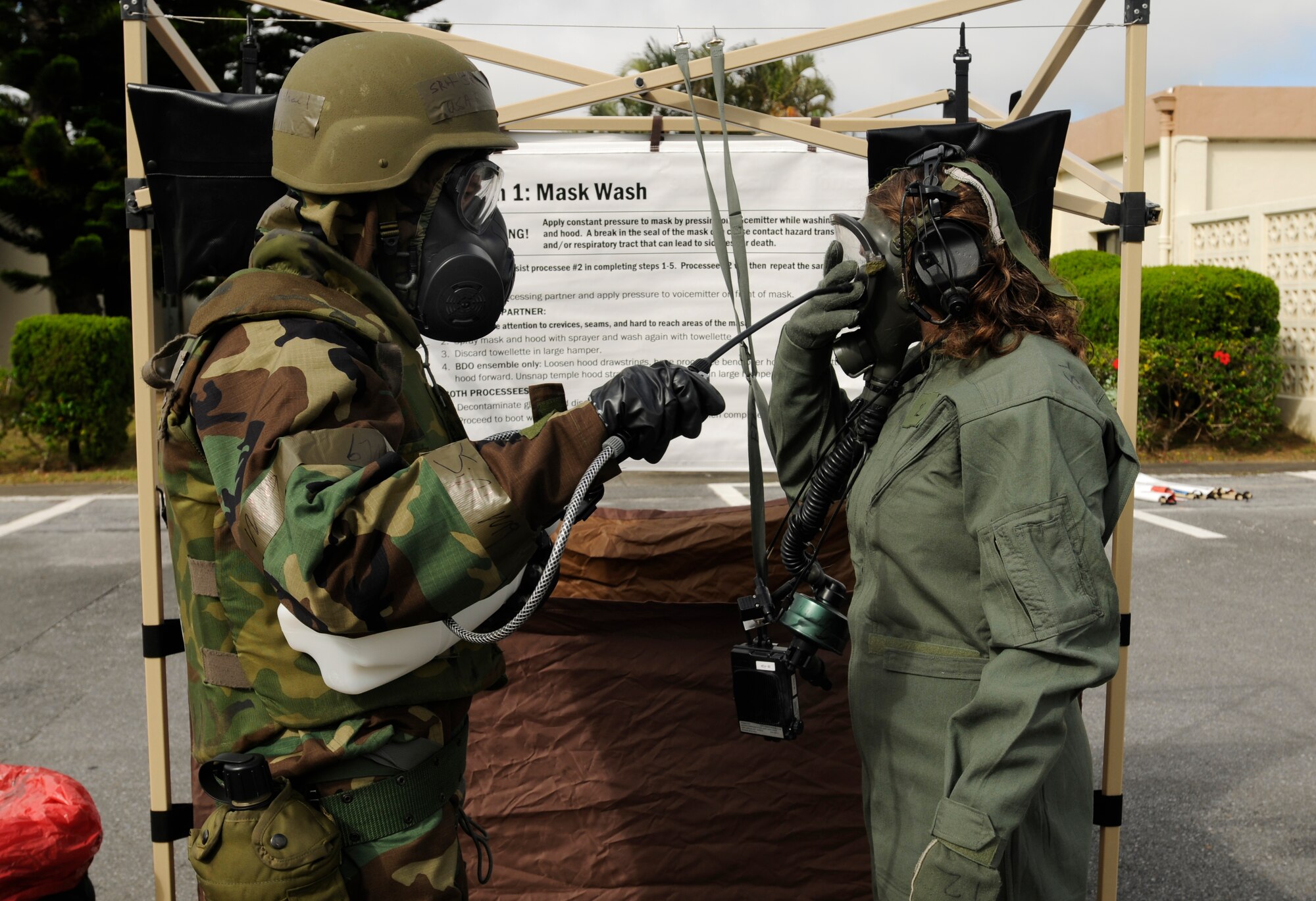Senior Airman Michael Stephens, 18th Operations Support Squadron, decontaminates an aircrew member during Beverly High 09-2 Local Operational Readiness Exercise May 13. The LORE tests base personnel on their combat readiness for real world emergency/combat events. 
(U.S. Air Force photo/Airman 1st Class Chad Warren)