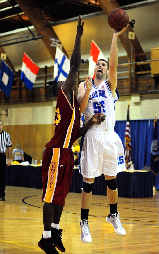 All Air Force center 2nd Lt. John Frye shoots over a defender for two points during a basketball game against the Marine Corps in Millington, Tenn., May 13, 2009. Frye scored seven points and had two rebounds during the 86-67 victory over the Marine Corps in the second round of games for the Armed Forces Basketball Championship.