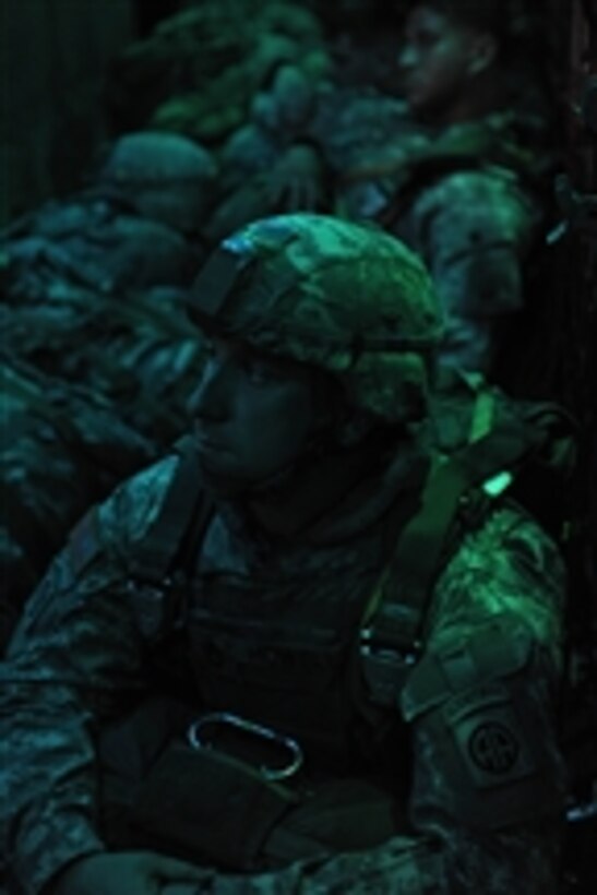 U.S. Army Sgt. 1st Class John Howell, with the 82nd Airborne Division, travels on a U.S. Air Force C-130 Hercules aircraft to a drop zone for a night static line jump during a joint forcible entry exercise over Fort Bragg, N.C., on April 30, 2009.  