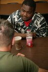 Lamar Mhoon, 35, speaks with Lance Cpl. Dawson Smith, 1st Marine Division, during the Marines visit to the Cornerstone Community Center in Chicago May 13. The Marines were on hand as a volunteer effort. The Marines helped in the kitchen and cleaned-up the centers basement as a part of the first ever Marine Week.
