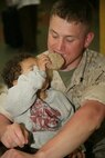 Cpl. Andrew Farrell gets force fed a cookie during lunch at the Cornerstone Community Center in Chicago May 13. The Marines were on hand to help in the kitchen with serving food and cleaning-up the centers basement as a part of the first ever Marine Week.