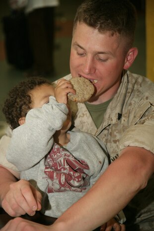 Cpl. Andrew Farrell gets force fed a cookie during lunch at the Cornerstone Community Center in Chicago May 13. The Marines were on hand to help in the kitchen with serving food and cleaning-up the centers basement as a part of the first ever Marine Week.