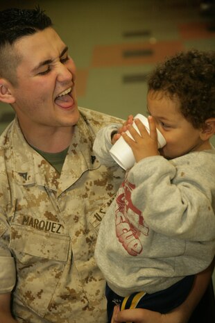Lance Cpl. Jesse Marquez interacts with Kendrick Thomas, 5, during lunch at Cornerstone Community Center in Chicago May 13. Aboout 25 Marines were on hand to help serve food and clean-up the basement of the shelter as a part of the first ever Marine Week.