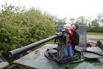 Joshua Carrel, 5, looks down the sights of a .50 caliber machine-gun with his father, David Carrell's, help. As a a part of Marine Week Chicago Marines held a static display at Sears Holdings May 13. People were allowed to mount the vehicles and handle some of the weapons Marines use on a daily basis. The event was one of many being held throughout the Chicago area.