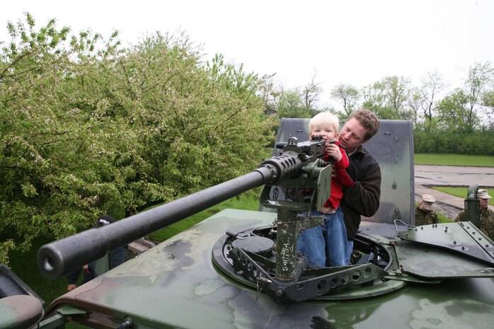 Joshua Carrel, 5, looks down the sights of a .50 caliber machine-gun with his father, David Carrell's, help. As a a part of Marine Week Chicago Marines held a static display at Sears Holdings May 13. People were allowed to mount the vehicles and handle some of the weapons Marines use on a daily basis. The event was one of many being held throughout the Chicago area.