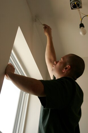 Chicago native, Cpl. Joseph Vaccaro, a warehouse clerk with 2nd Battalion, 24th Marine Regiment based in Chicago, paints the interior of a newly built home in Chicago’s South Side on South Lamon Street,  a few blocks away from where Vaccaro grew up.::r::::n::