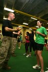 Sgt. Joshua P. Ott, 24, a martial arts instructor trainer based out of Quantico, Va., answers a question for Alexandra T. Leach, 22, a biology-major from Gurnee, Ill., during a self defense class at the Martial Arts Center of Education, University of Chicago May 14. The class consisted of 15 techniques and was given to three sororities from the university.
