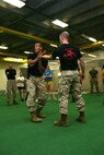 Sgt. Shurron D. Thompson, 23, breaks Sgt. Joshua P. Ott's, 24, grip. As part of Marine Week Chicago Marines with the Martial Arts Center of Excellence based out of Quantico, Va., showcased self defense techniques to three sororities from the University of Chicago May 14. The martial arts instructor trainers taught the girls in attendance 15 techniques.