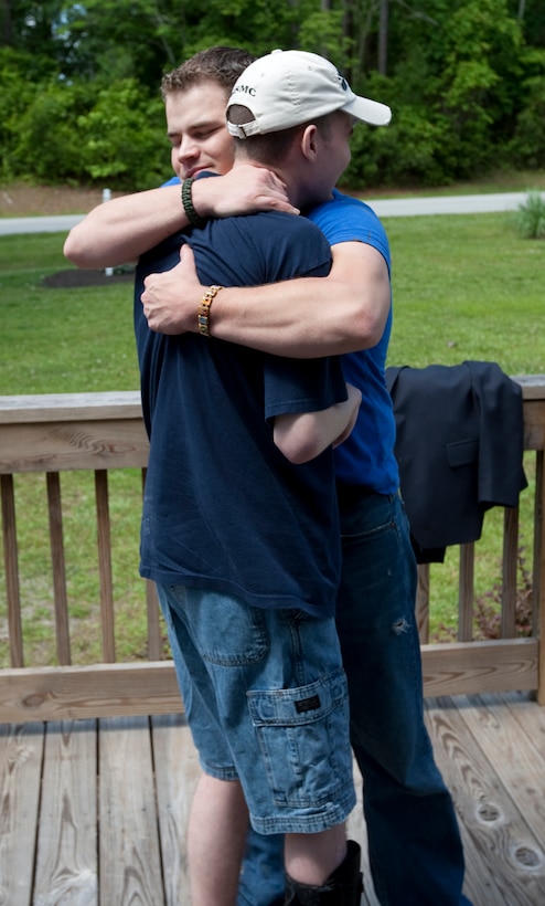 LCpl. Colin Smith shares a reuniting hug with Petty Officer Third Class Dustin Kirby, the Navy Corpsman who treated Smith after sustaining a sniper shot to the head in Iraq in 2006. It has been nearly three years since these wounded warriors have seen each other after the attack. Official Marine Corps photo by Lance Cpl. Jonathan Wright.