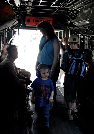 Local residents and military families examine a CH-53 Super Stallion during the 2009 Joint Service Open House May 15. Marines presented multiple aircraft displays for the public, while aviators and stunt pilots from the Army, Air force and Navy performed maneuvers and demonstrated evasive actions taken in combat.