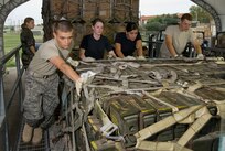 Students in the basic loadmaster course practice loading pallets onto a K loader, a lift used to load cargo onto aircraft. (U.S. Air Force photo/Master Sgt. Rene DeLaRosa)