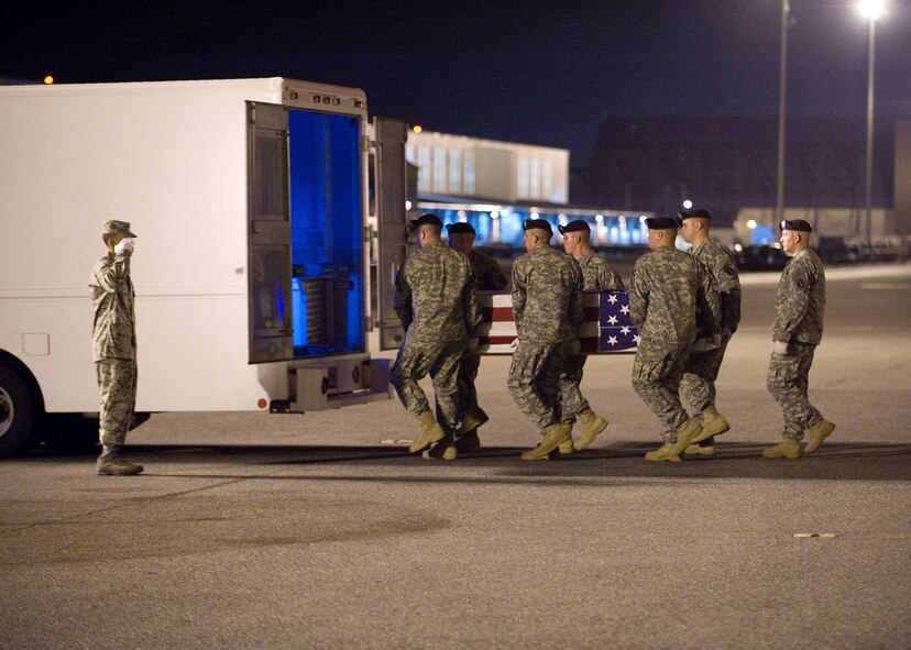 An Army carry team transfers the remains of Army Staff Sgt. Christian E. Bueno-Galdos, of Paterson, N.J., at Dover Air Force Base, Del., May 13. Sergeant Bueno-Galdos was assigned to the 3rd Battalion, 66th Armor Regiment, 172nd Infantry Brigade, Grafenwoehr, Germany.  (US Air Force photo/Roland Balik)