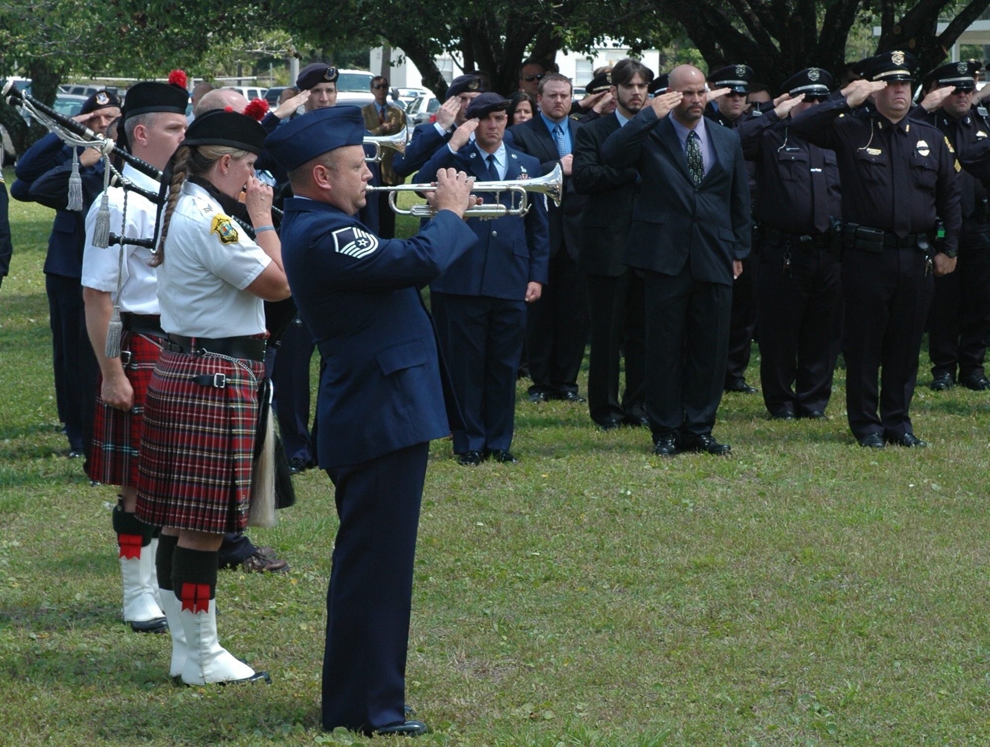 Master Sergeant Steve Harbison, 325th Fighter Wing honor guard, plays taps during the shared memorial service May 14, which honored seven Security Forces Airmen and eight Florida Police Officers that died in the line of duty.  (U.S. Air Force photo/2nd Lt. Cody Chiles)