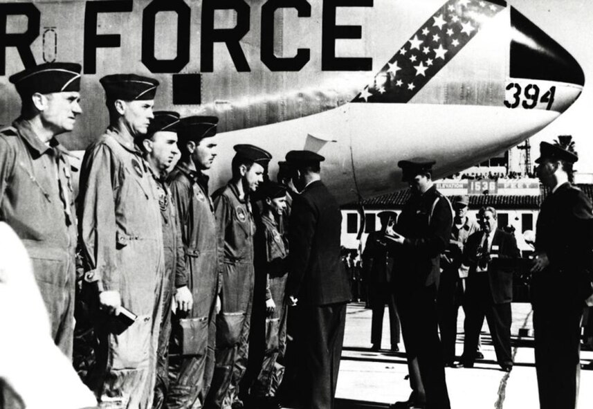 During a ceremony at March AFB, Calif., on Jan. 18, 1957, Gen. Curtis E. LeMay, Commander in Chief of Strategic Air Command, presents the Distinguished Flying Cross to the crew of Lucky Lady III. At far left is Maj. Gen. Archie J. Old Jr., Fifteenth Air Force commander. The aide behind General Lemay is Maj. David C. Jones, later to become Air Force chief of staff and chairman of the joint chiefs. 