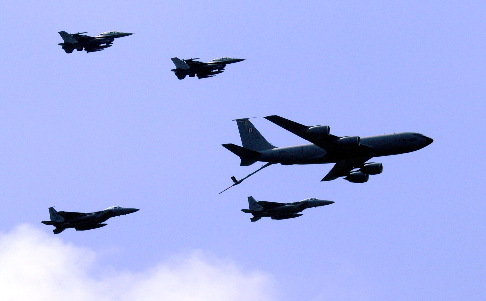 A formation of F-16s, F-15s, and a KC-135 fly over RAF Mildenhall during the 75th Anniversary of the base May 15, 2009.  The five aircraft formation was one part of a larger demonstration of air power, complete with simulated bomb impacts.  (U.S. Air Force photo by Senior Airman Christopher L. Ingersoll)
