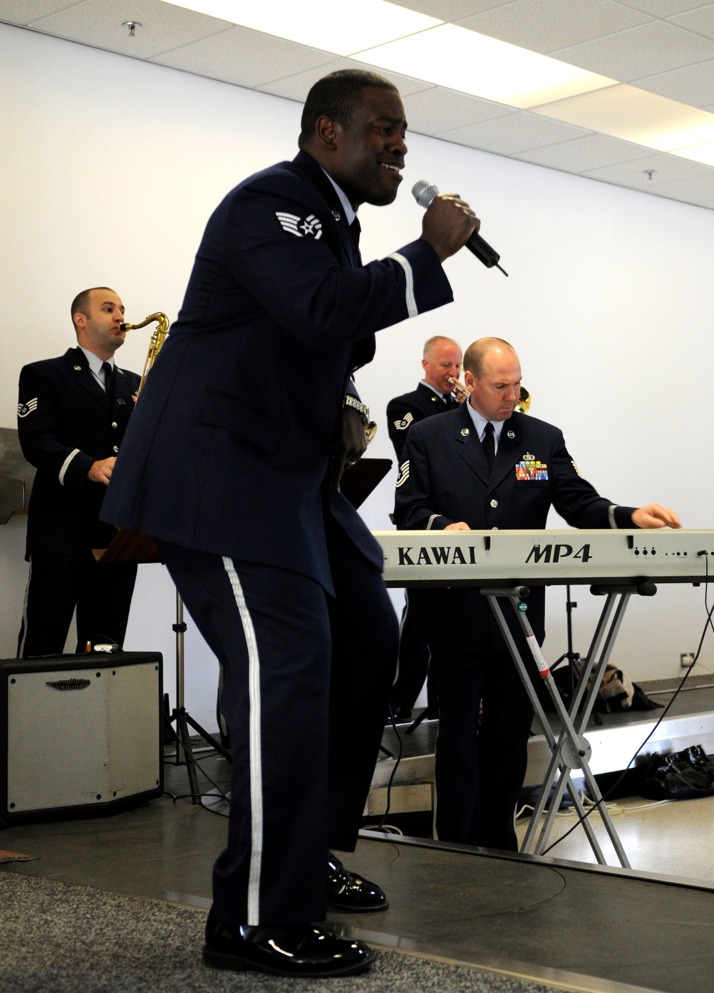 Staff Sgt. Andre Rascoe, a vocalist with the U.S. Air Forces in Europe Band, performs for a captive audience at the RAF Mildenhall 75th anniversary celebration, May 15, 2009.  The band operates out of  Sembach Air Base Germany, and performs all over Europe.  (U.S. Air Force photo by Senior Airman Christopher L. Ingersoll)