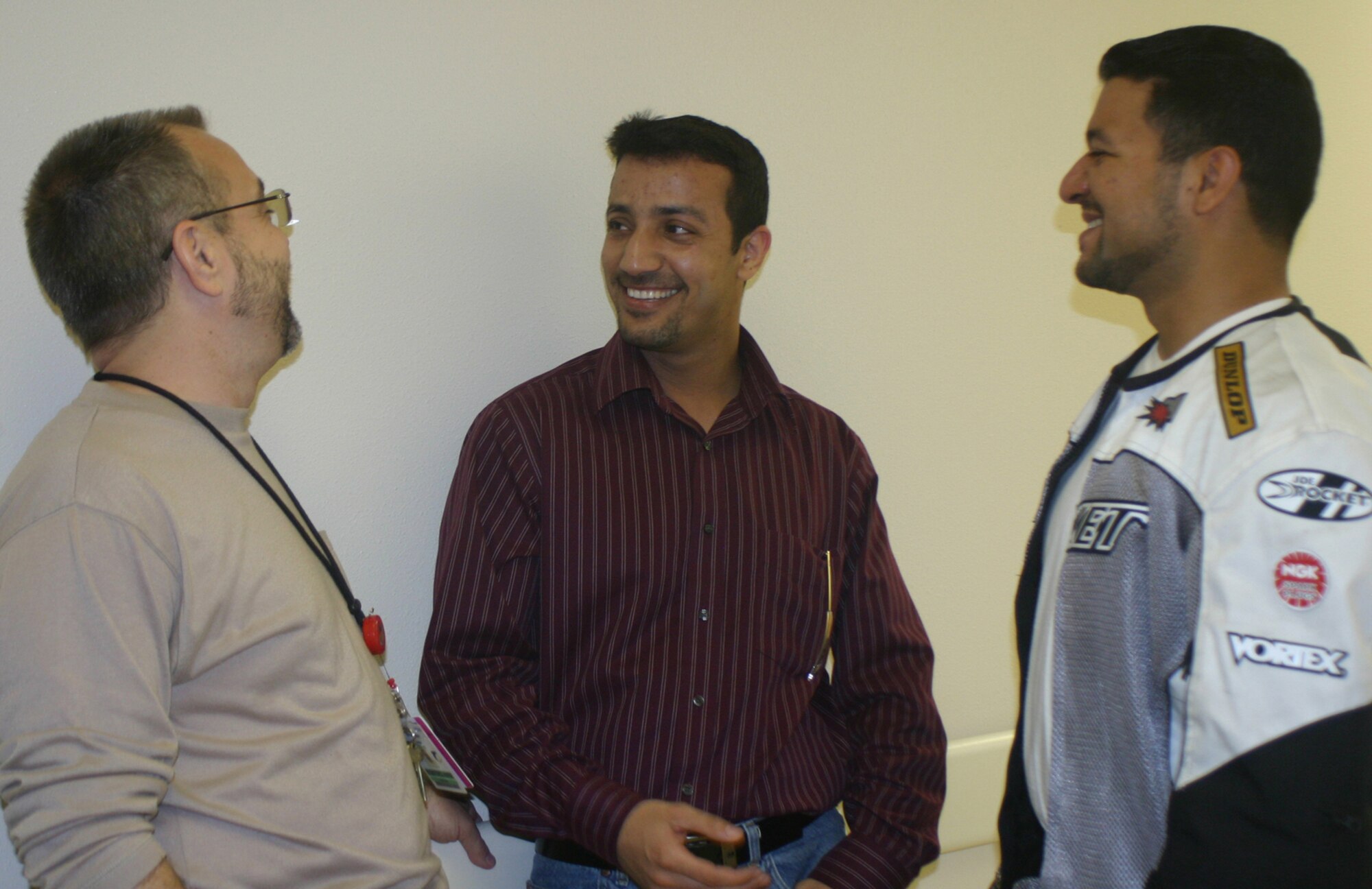 Ali Aziz Resan (center) reminisces with Staff Sgt. Robert Ayala, neurology technician in the 59th Medical Operations Squadron (right), and George Brandon, clinical nurse in the 59th Medical Inpatient Squadron, during a visit to Wilford Hall Medical Center, Lackland Air Force Base, Texas, May 8.  The two Wilford Hall staff members knew Mr. Resan when he served as an Arabic translator at the Tallil Air Base hospital in Iraq.  Mr. Resan is joining the Texas National Guard and working to obtain U.S. citizenship. (U.S. Air Force photo/Sue Campbell)