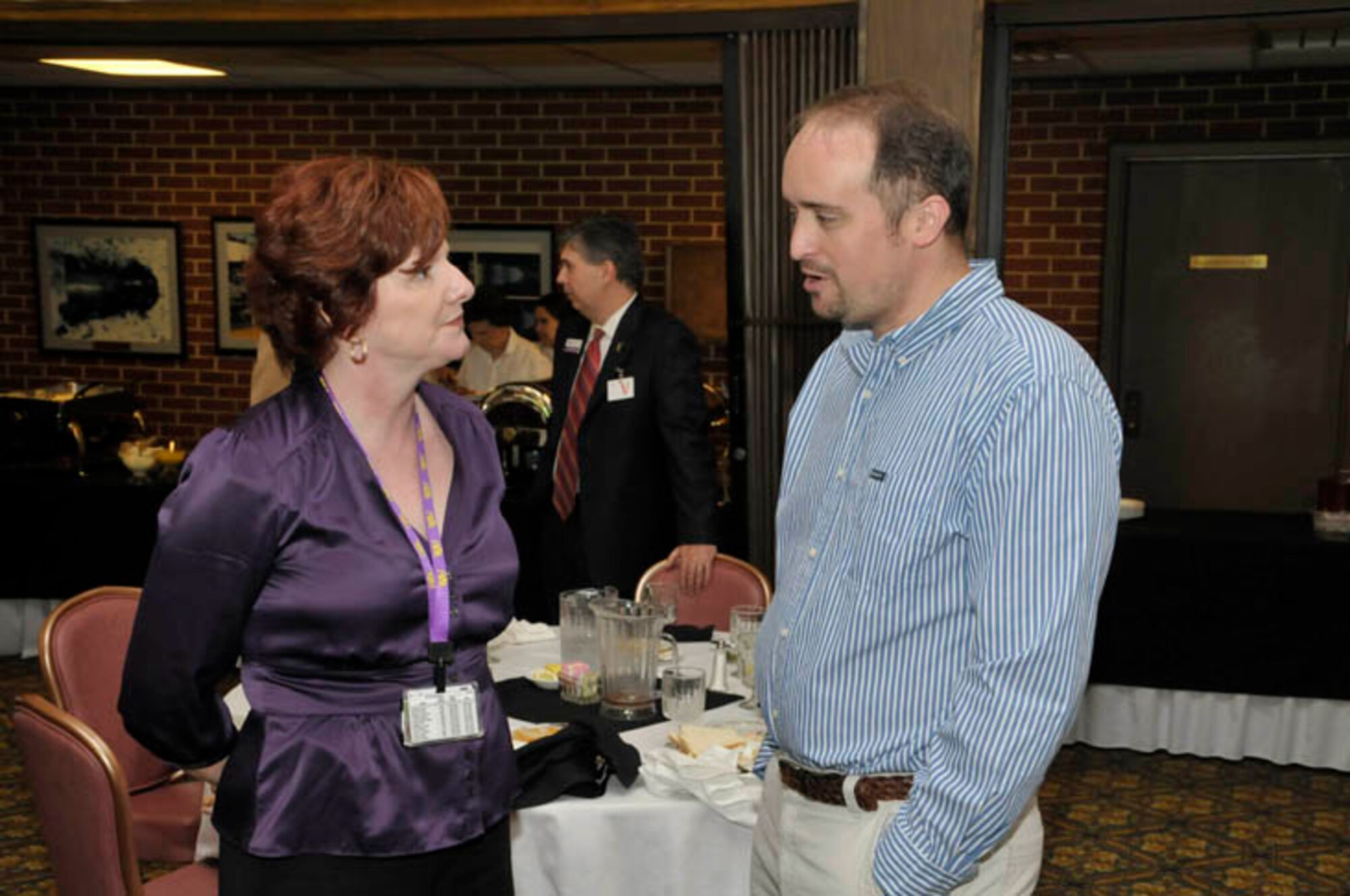 (From right) Chris Davis (TTU class of 2000), a computer programmer in Aerospace Testing Alliance’s (ATA) technology department discusses the support contractor’s college internship program with ATA Deputy Director of the Project and Design Engineering Department Sharon Carter (TTU Class of 1986) during the TTU alumni luncheon Wednesday. (Photo by Rick Goodfriend)