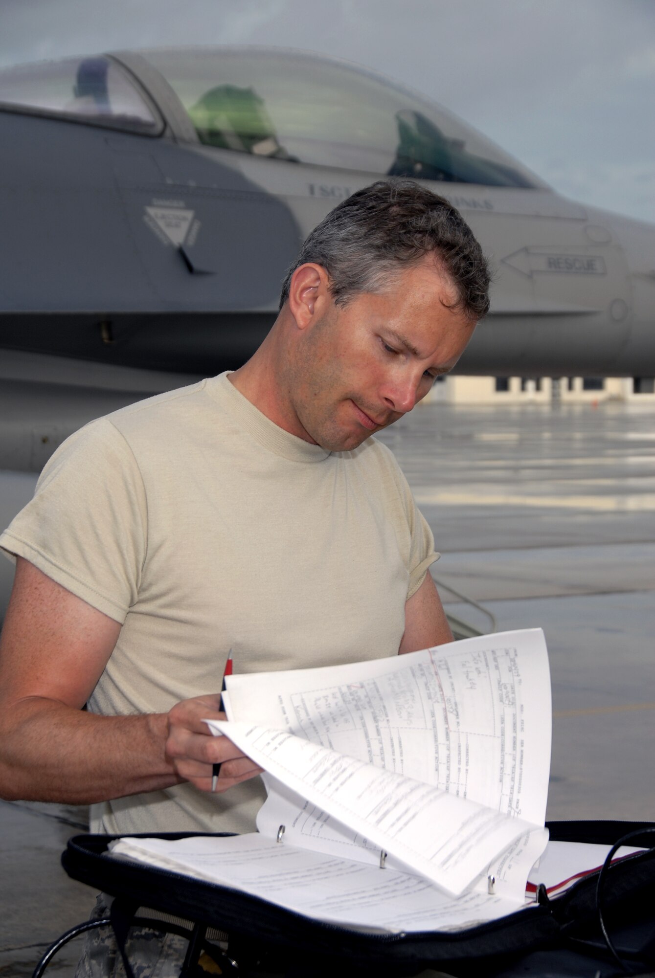 Technical Sgt. Mike Hall, a crew chief with the 115th Fighter Wing, Madison, Wis., documents completed checklist items while preparing one of the units F-16C Fighting Falcons for launch April 30, 2009.  The 115th FW participated in an air-to-air combat skills training exercise April 18 - May 2, 2009 along side their naval counterparts from Strike Fighter Squadron 2 (VFA-2), Naval Air Station Lemoore, Calif., while deployed to Naval Air Station Key West, Fla.  The training missions featured air-to-air and air-to-ground offensive and defensive combat tactics designed to simulate real-world operations.  (U.S. Air Force photo by: Master Sgt. Dan Richardson)