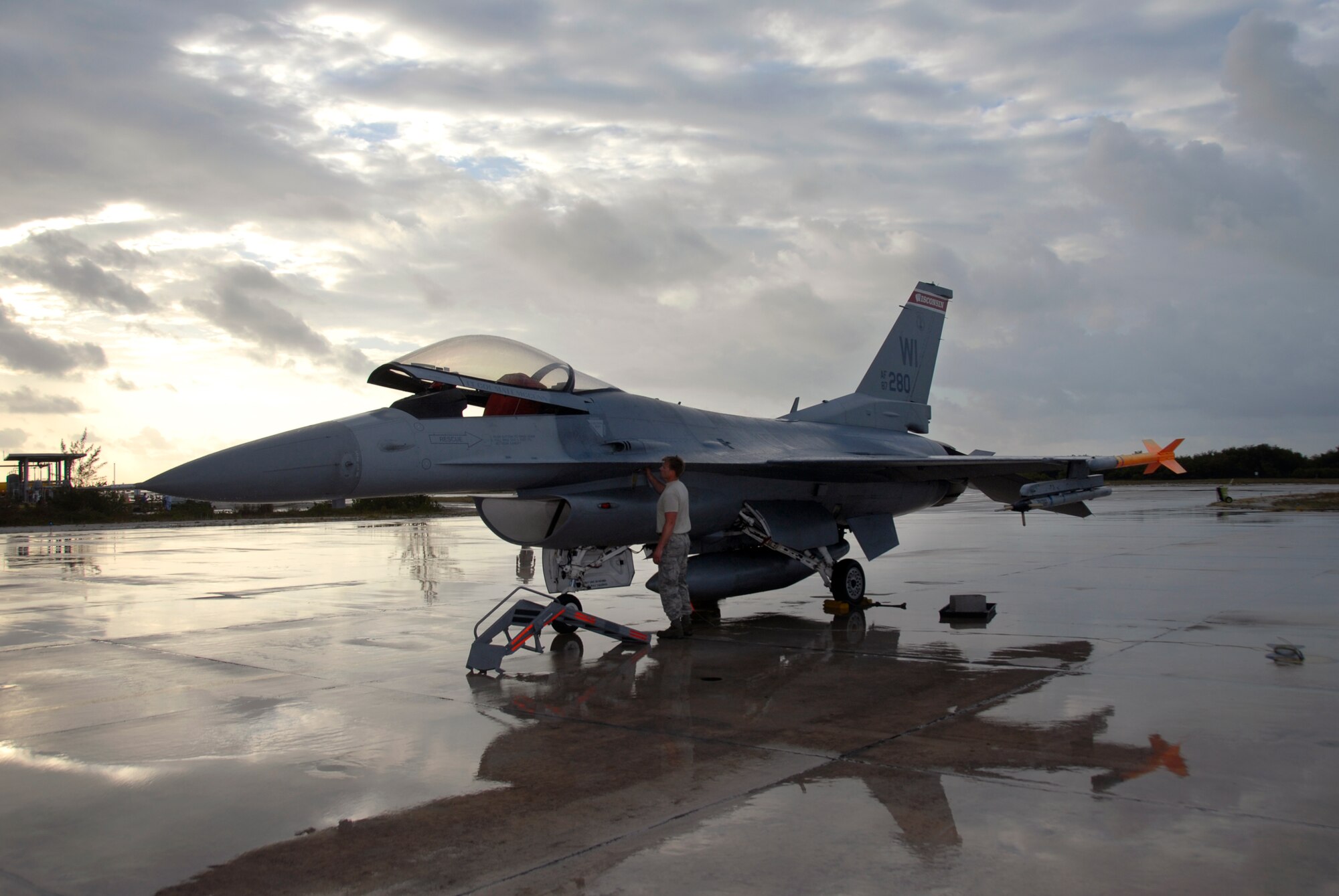 Staff Sgt. Brian Gilbertson, a crew chief with the 115th Fighter Wing, Madison, Wis.,  prepares one of the units F-16C Fighting Falcons for flight after a rain storm April 30, 2009.  The 115th FW participated in an air-to-air combat skills training exercise April 18 - May 2, 2009 along side their naval counterparts from Strike Fighter Squadron 2 (VFA-2), Naval Air Station Lemoore, Calif., while deployed to Naval Air Station Key West, Fla.  The training missions featured air-to-air and air-to-ground offensive and defensive combat tactics designed to simulate real-world operations.  (U.S. Air Force photo by: Master Sgt. Dan Richardson)