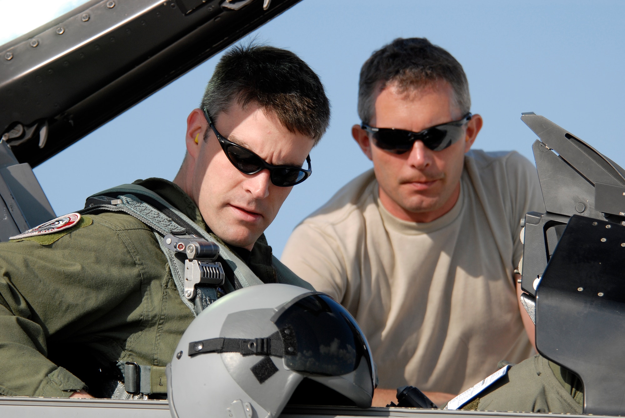 Capt.Tony Hart, an F-16 fighter pilot is assisted by Technical Sgt. Mike Hall, a crew chief, strapping into the cockpit of an F-16C Fighting Falcon.  Both are members of 115th Fighter Wing, Madison, Wis. 115th FW participated in an air-to-air combat skills training exercise April 18 - May 2, 2009 along side their naval counterparts from Strike Fighter Squadron 2 (VFA-2), Naval Air Station Lemoore, Calif., while deployed to Naval Air Station Key West, Fla.  The training missions featured air-to-air and air-to-ground offensive and defensive combat tactics designed to simulate real-world operations.  (U.S. Air Force Photo by Master Sgt. Dan Richardson)