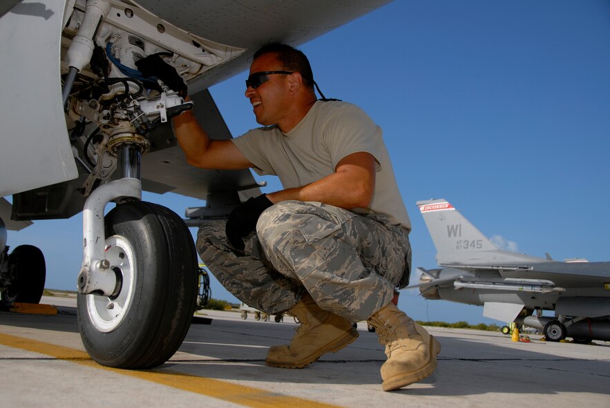 Staff Sgt. Jose Irizarry, a crew chief with the 115th Fighter Wing, Madison, Wis., inspects the nose gear on one of the units F-16C Fighting Falcons prior to the days missions April 29, 2009. The 115th FW participated in an air-to-air combat skills training exercise April 18 - May 2, 2009 along side their naval counterparts from Strike Fighter Squadron 2 (VFA-2), Naval Air Station Lemoore, Calif., while deployed to Naval Air Station Key West, Fla.  The training missions featured air-to-air and air-to-ground offensive and defensive combat tactics designed to simulate real-world operations.  (U.S. Air Force photo by Master Sgt. Dan Richardson)