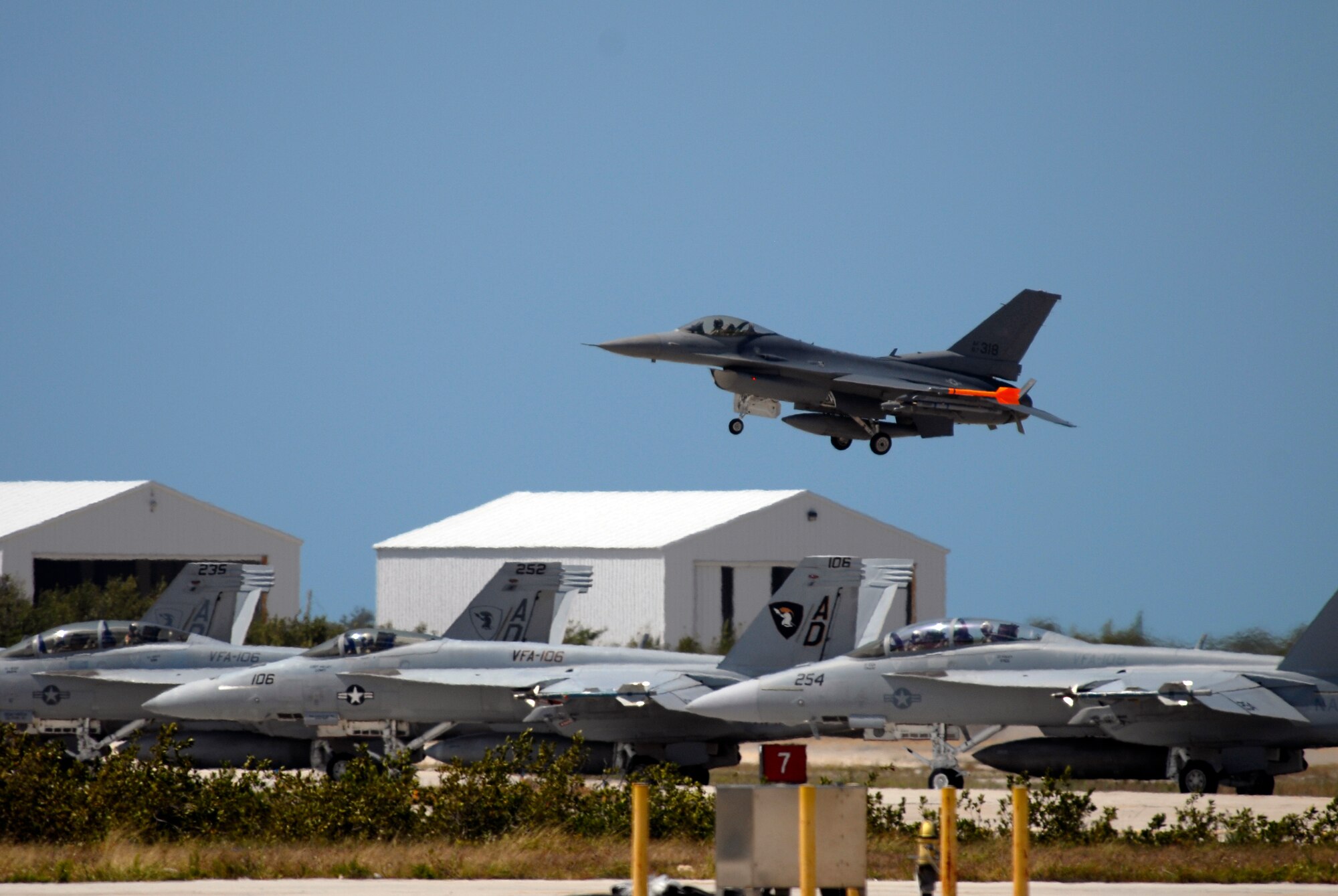 An F-16C Fighting Falcon from the 115th Fighter Wing, Madison, Wis., lands while FA-18 Hornets from Strike Fighter Squaron 2 (VFA-2), Naval Air Station Lemoore, Calif. prepare for takeoff April 30, 2009. The 115th FW participated in an air-to-air combat skills training exercise April 18 - May 2, 2009 along side their naval counterparts while deployed to Naval Air Station Key West, Fla.  The training missions featured air-to-air and air-to-ground offensive and defensive combat tactics designed to simulate real-world operations. (U.S. Air Force Photo by Master Sgt Dan Ricahrdson)